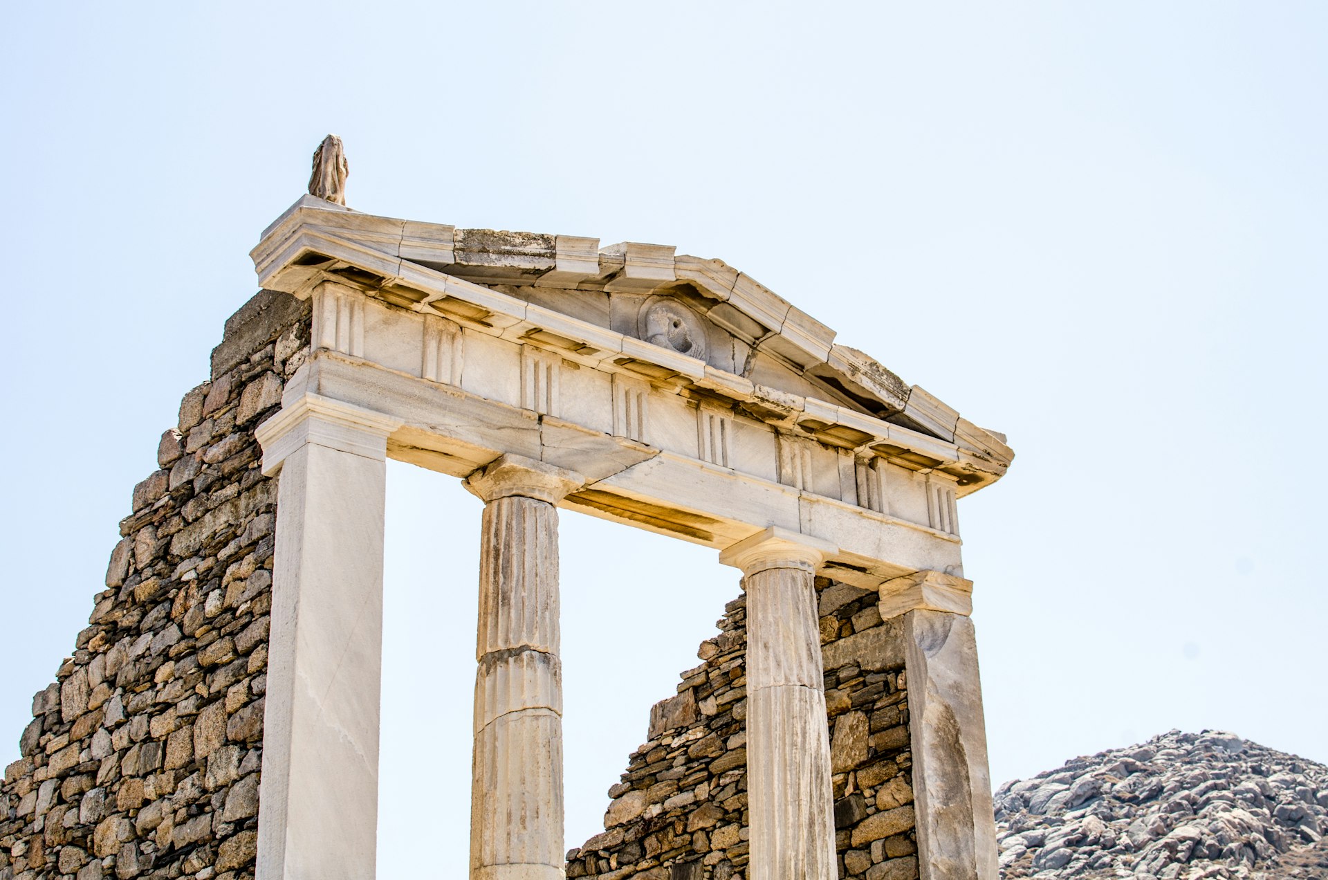 ruins of classical greek architecture carved in marble on the island of delos near mykonos in greece