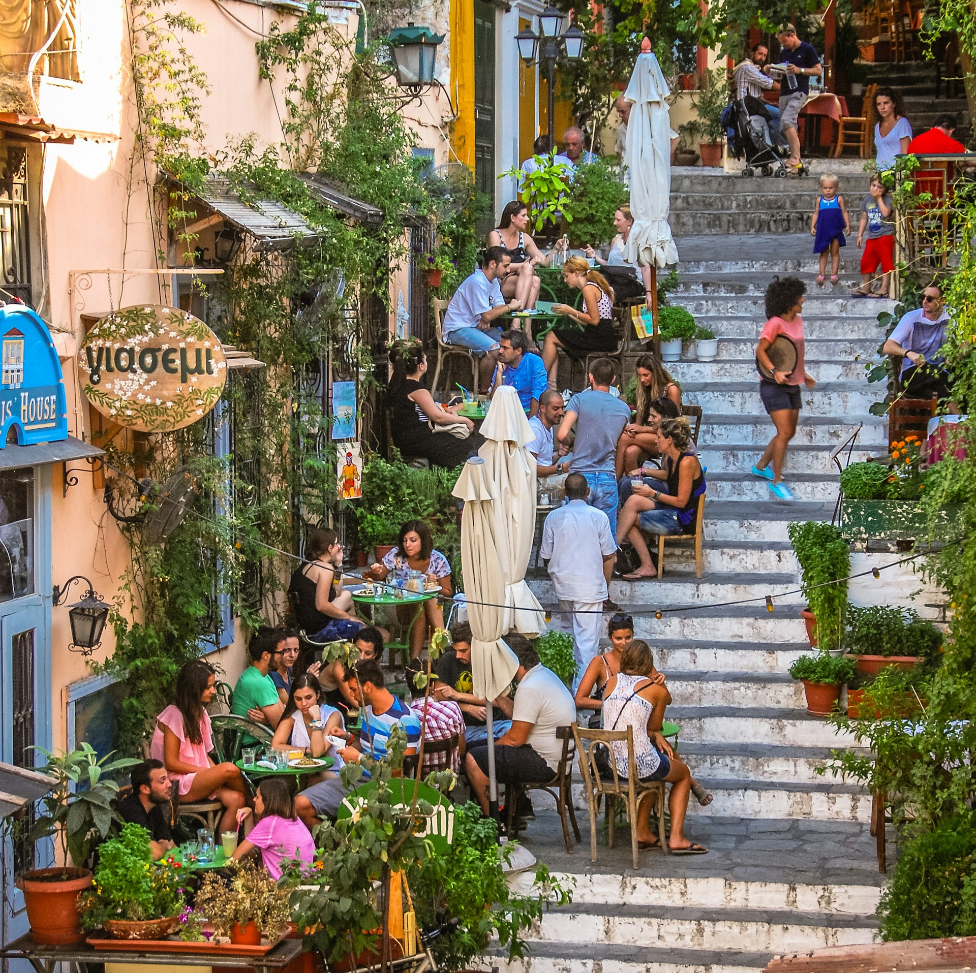 People dining outside on the stairs in the Plaka district of Athens