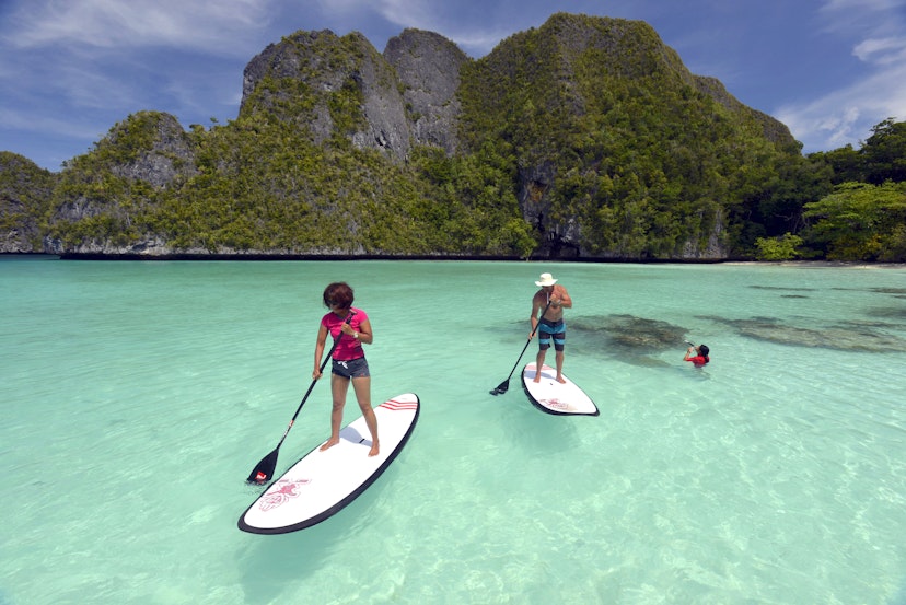 Tourists Stand up paddling in Wayag Island Raja Ampat Indonesia January 2016; Shutterstock ID 684582193; your: Sloane Tucker; gl: 65050; netsuite: Online Editorial; full: Raja Ampat Article