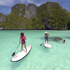 Tourists Stand up paddling in Wayag Island Raja Ampat Indonesia January 2016; Shutterstock ID 684582193; your: Sloane Tucker; gl: 65050; netsuite: Online Editorial; full: Raja Ampat Article