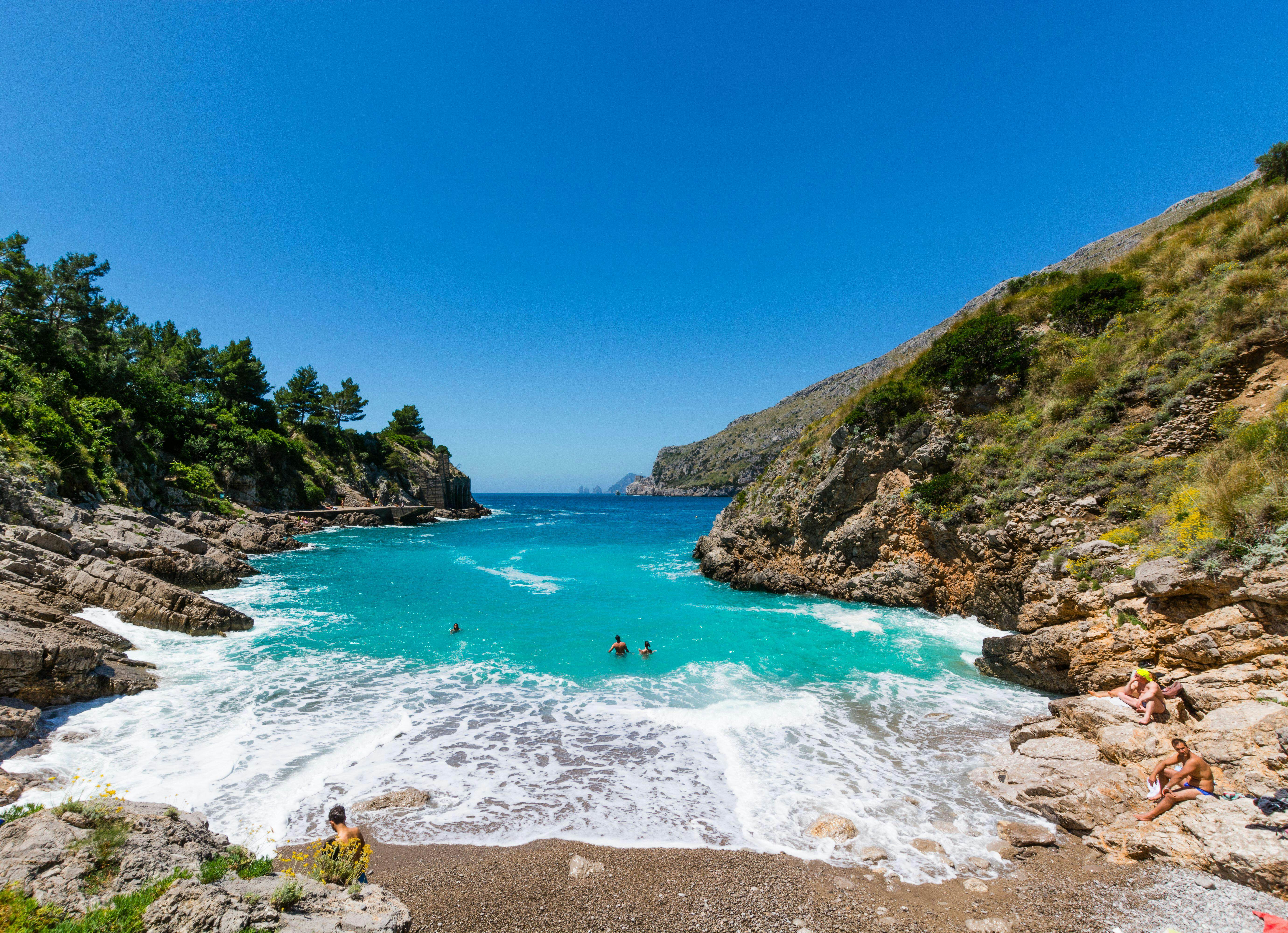 Swimming in the blue sea in Baia di Ieranto, Nerano, Naples