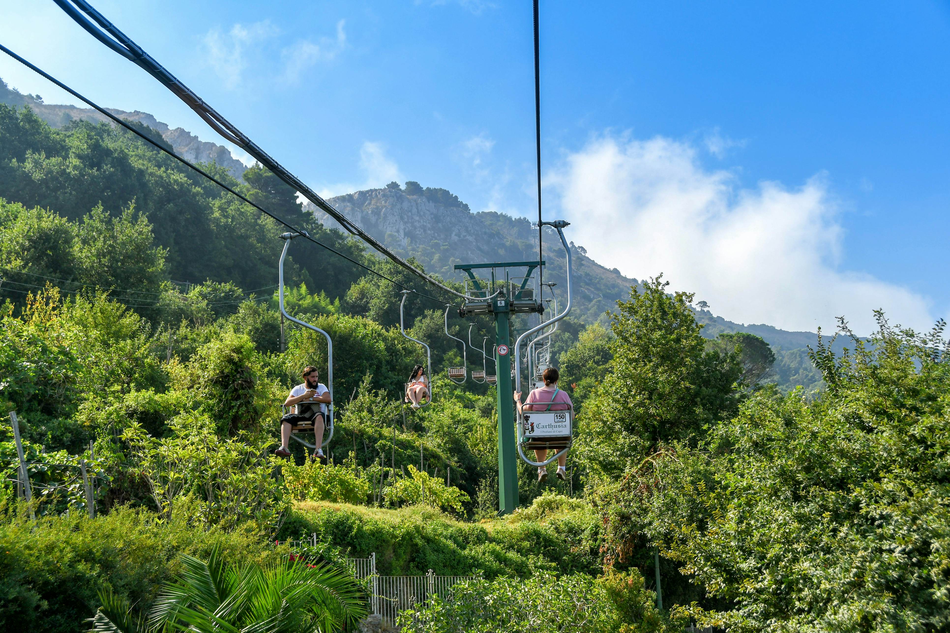 Person on a chairlift ascending Mount Solaro on Capri