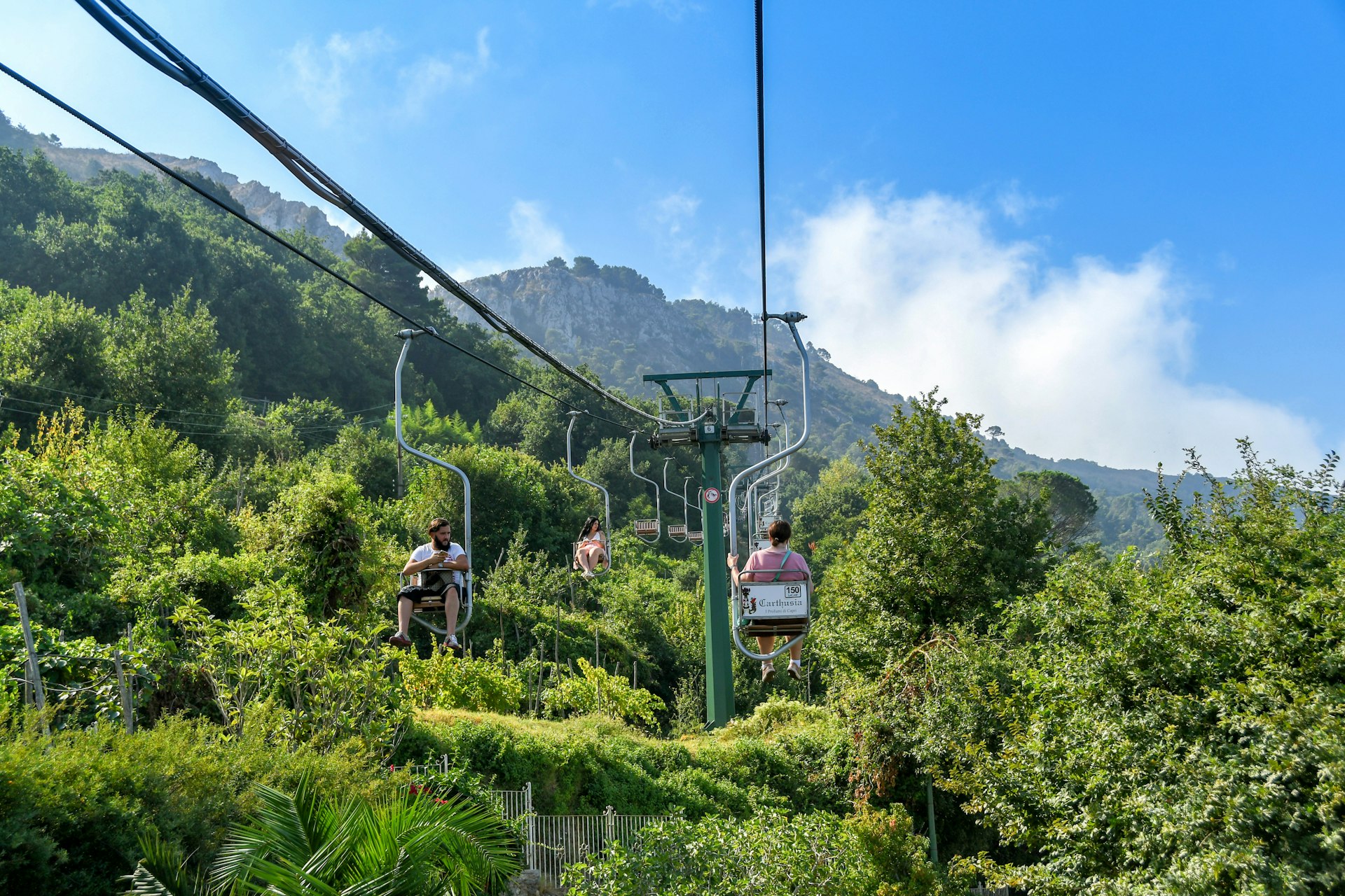 Person on a chairlift ascending Mount Solaro on Capri