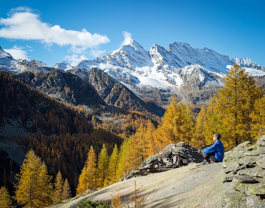 Panoramic landscape of trekker relaxing on the mountains