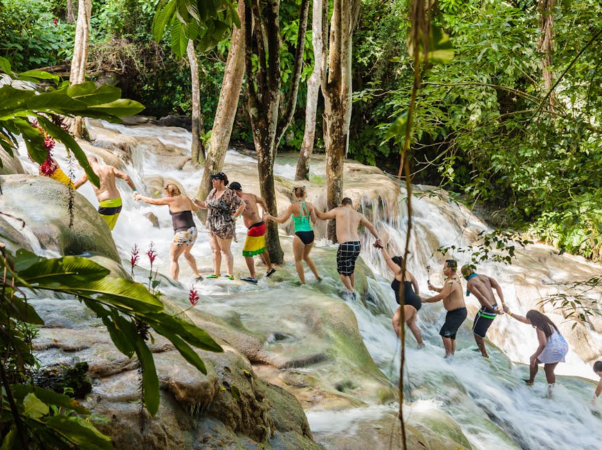 Tourists climb the Dunn River Falls in Ocho Rios, Jamaica