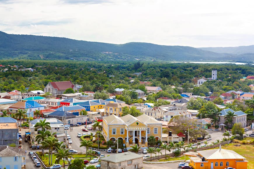Overhead shot of the town of Falmouth Port in Jamaica – lots of brightly colored buildings surrounded by trees and mountains