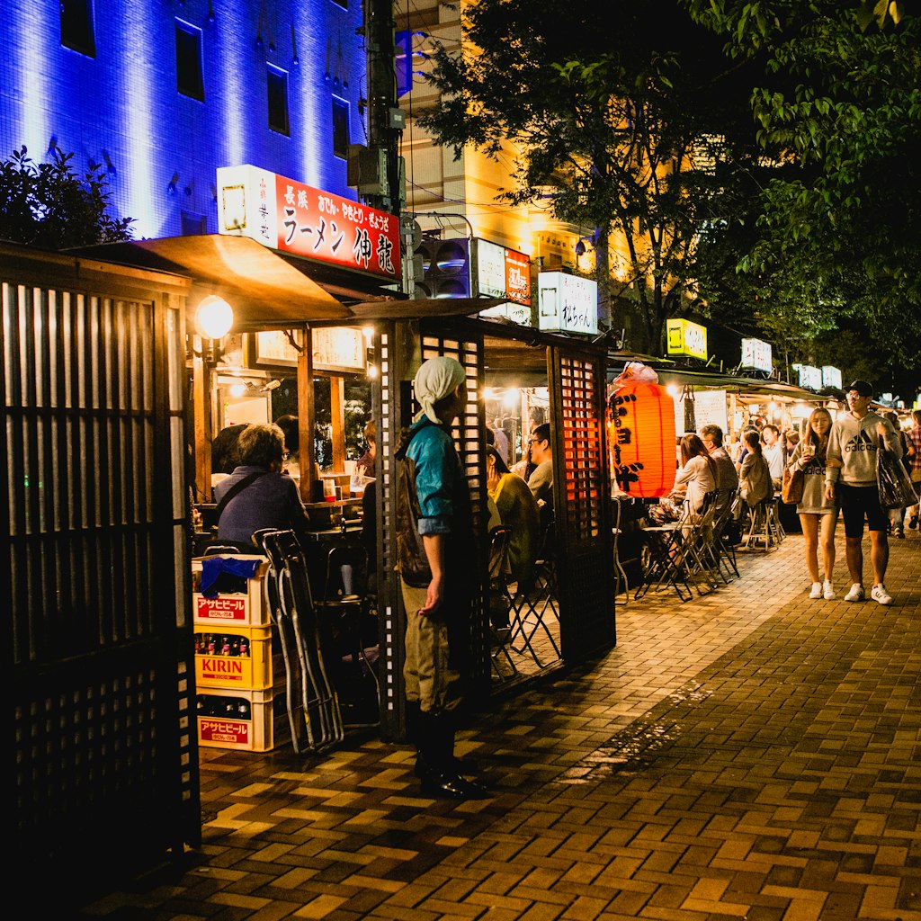 FUKUOKA, JAPAN - SEPTEMBER 26, 2016: People eating Yatai mobile food stall at night in Fukuoka, Kyushu, Japan; Shutterstock ID 709822984; your: Sloane Tucker; gl: 65050; netsuite: Online Editorial; full: Things to Do Fukuoka Article