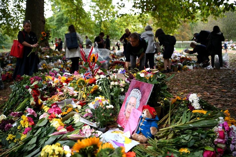 LONDON, ENGLAND - SEPTEMBER 13:  Members of the public visit the flowers in Green Park in memory of Queen Elizabeth II on September 13, 2022 in London, England. Elizabeth Alexandra Mary Windsor was born in Bruton Street, Mayfair, London on 21 April 1926. She married Prince Philip in 1947 and acceded to the throne of the United Kingdom and Commonwealth on 6 February 1952 after the death of her Father, King George VI. Queen Elizabeth II died at Balmoral Castle in Scotland on September 8, 2022, and is succeeded by her eldest son, King Charles III. (Photo by Shaun Botterill/Getty Images)