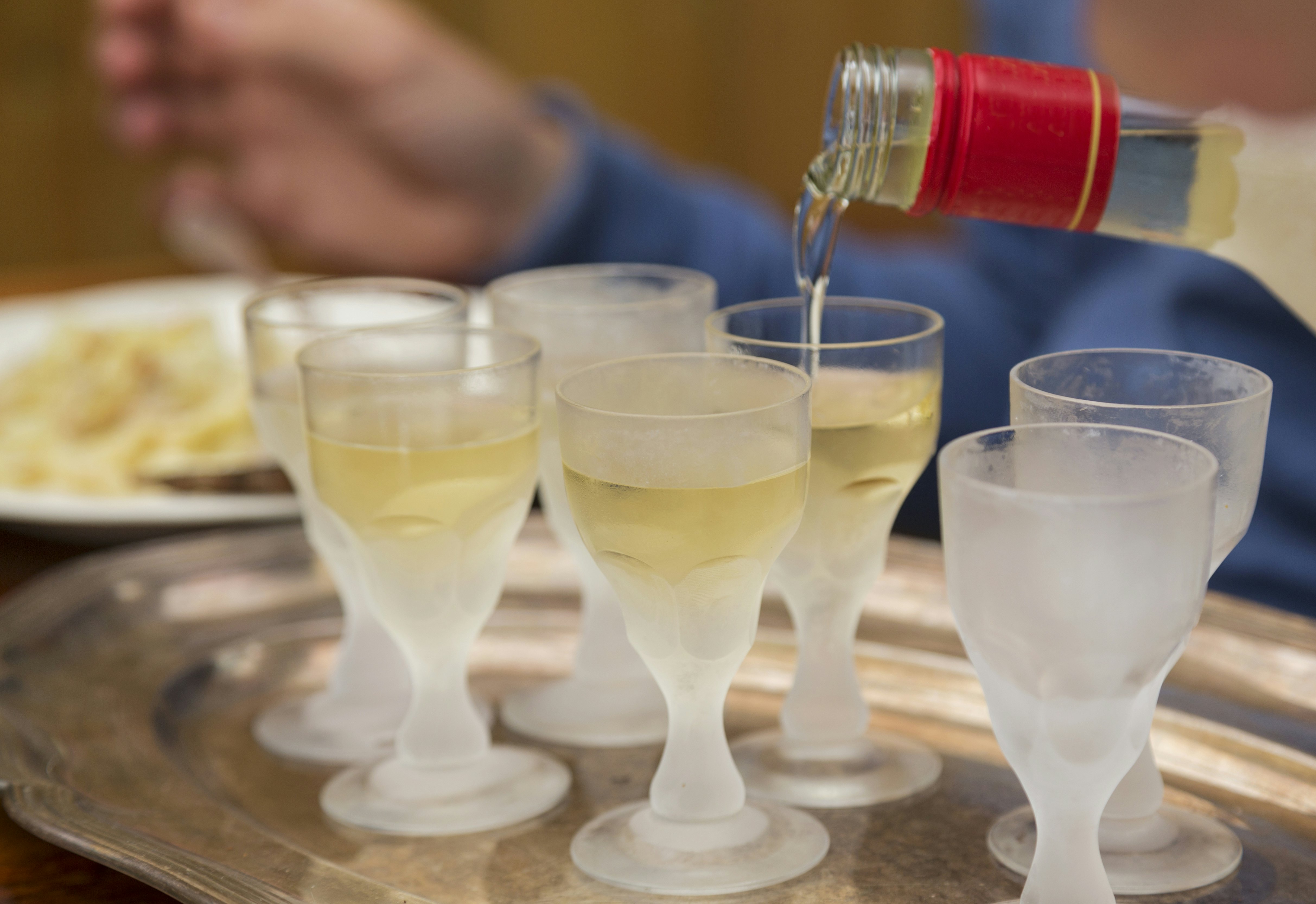 Pouring Aquavit into frosted glasses. Ready to celebrate Swedish midsummer.