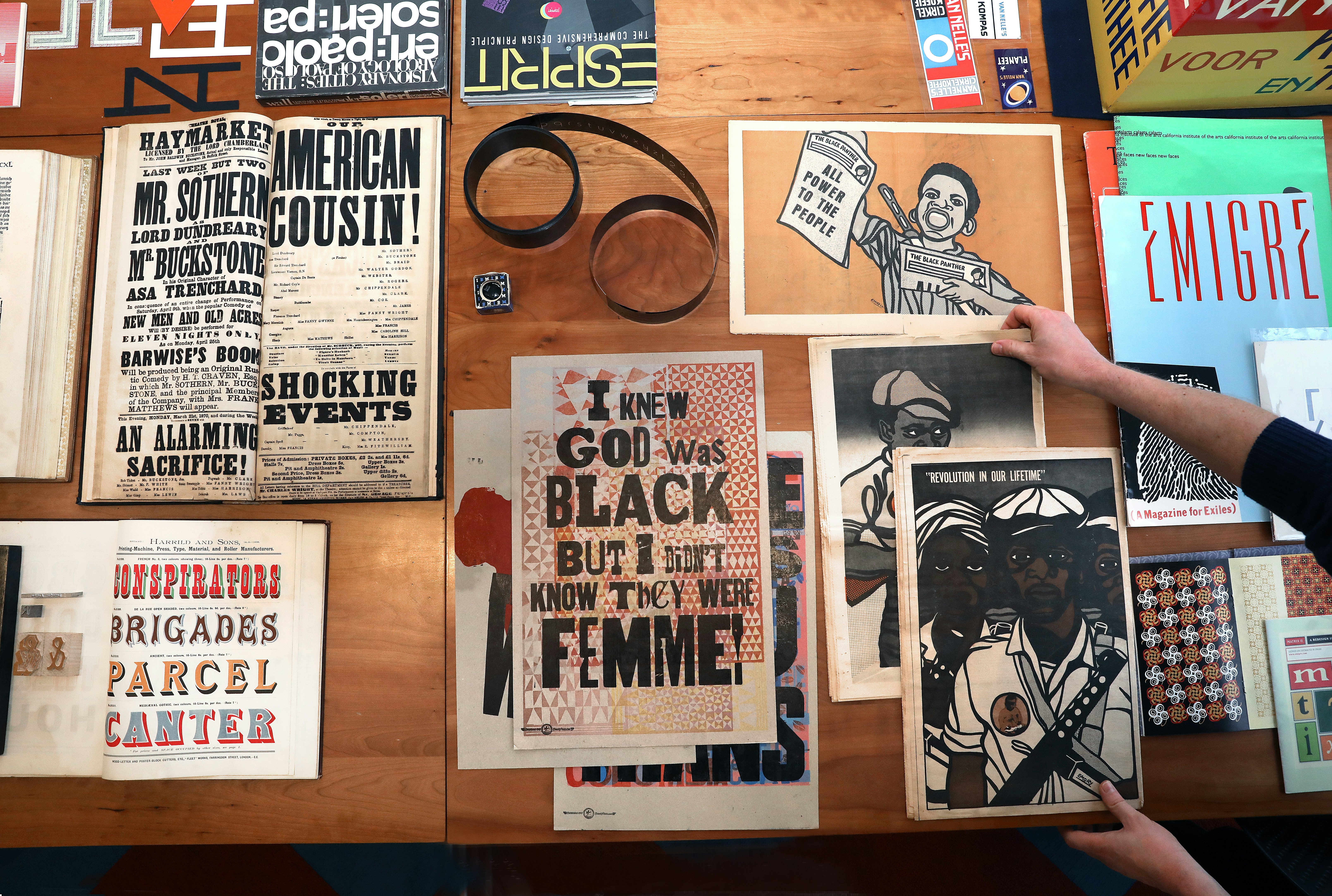 Protest posters from history lay flat on a table.