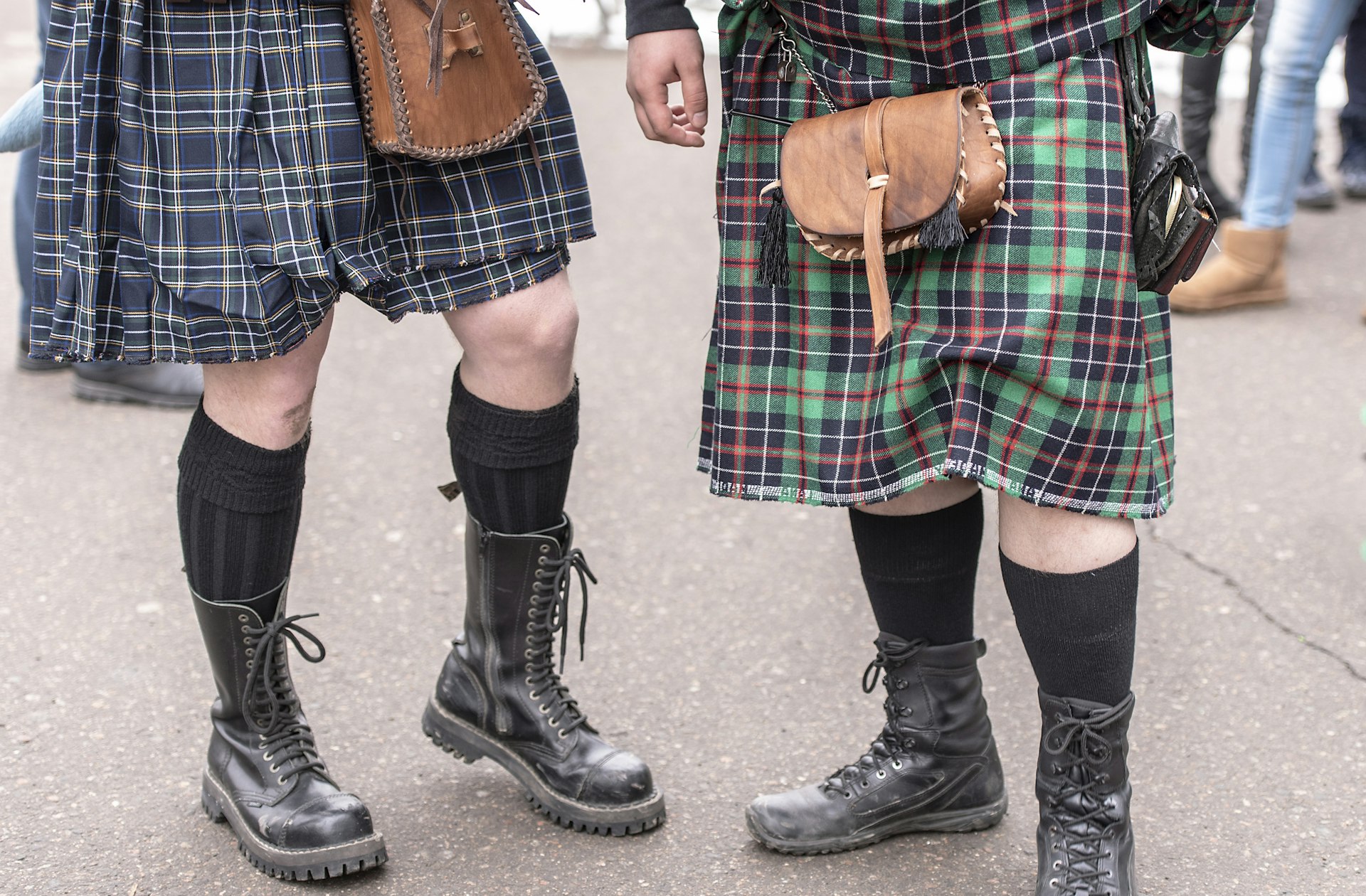 Two bagpipers wearing traditional Scottish kilts