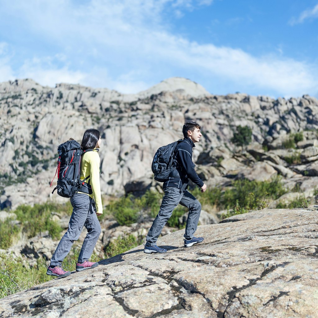 Young couple hiking on mountain trail . Spain, Sierra de Guadarrama.