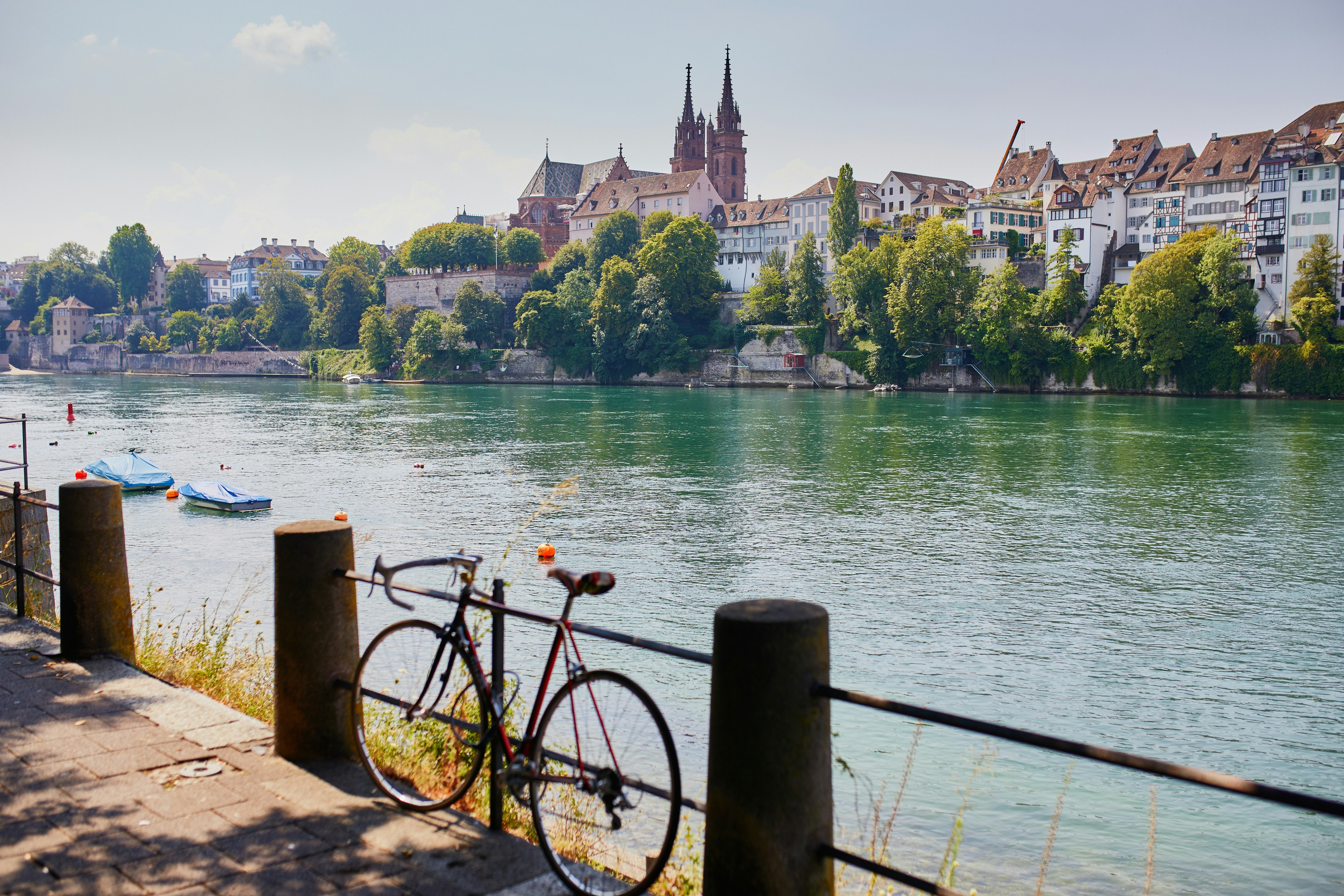 Scenic view of Rhine embankment with people swimming in the river in Basel, Switzerland 