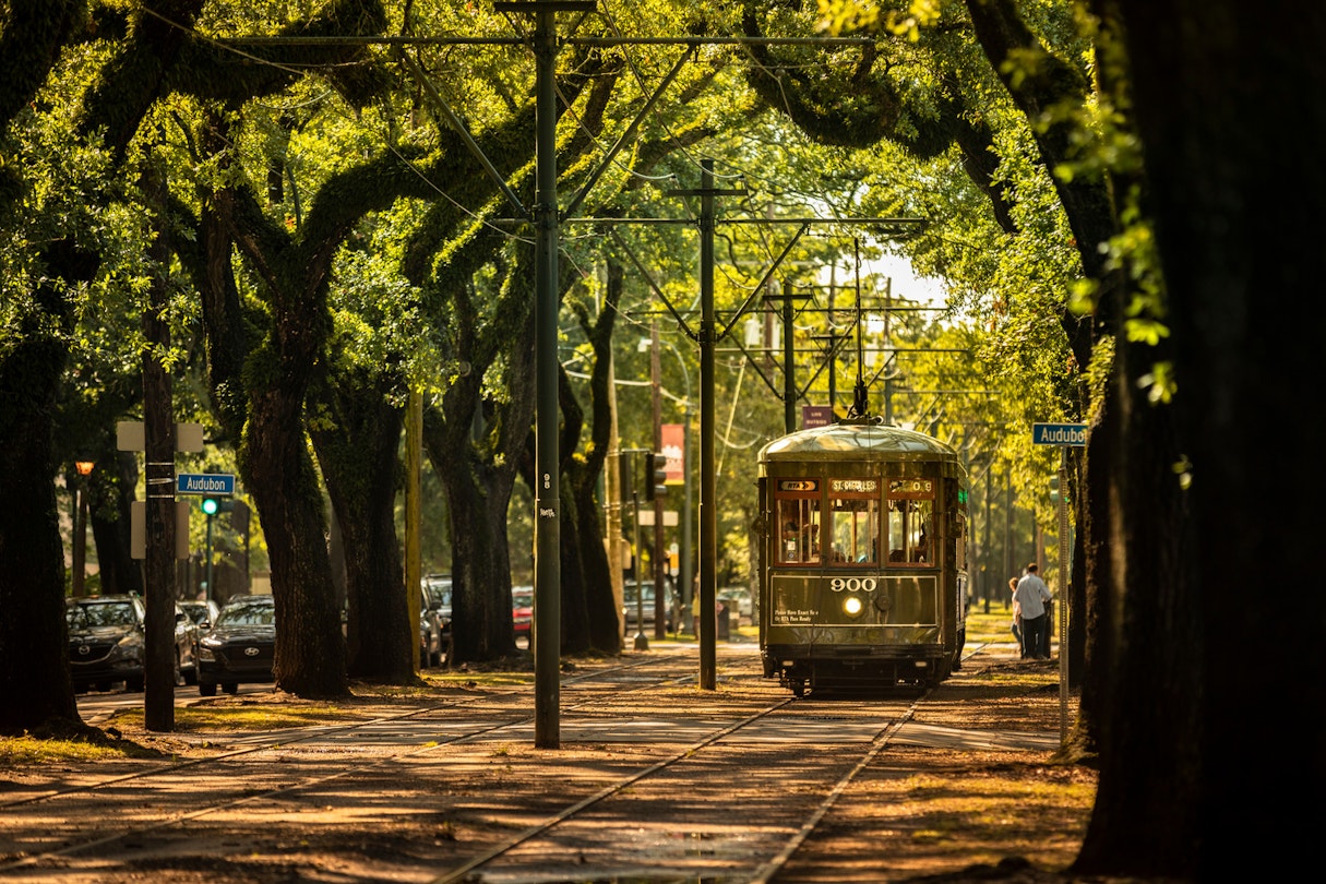 New Orleans, Louisiana - June 18, 2019: Passengers ride the historic railway streetcar along Saint Charles Avenue in the Garden District of New Orleans Louisiana USA.