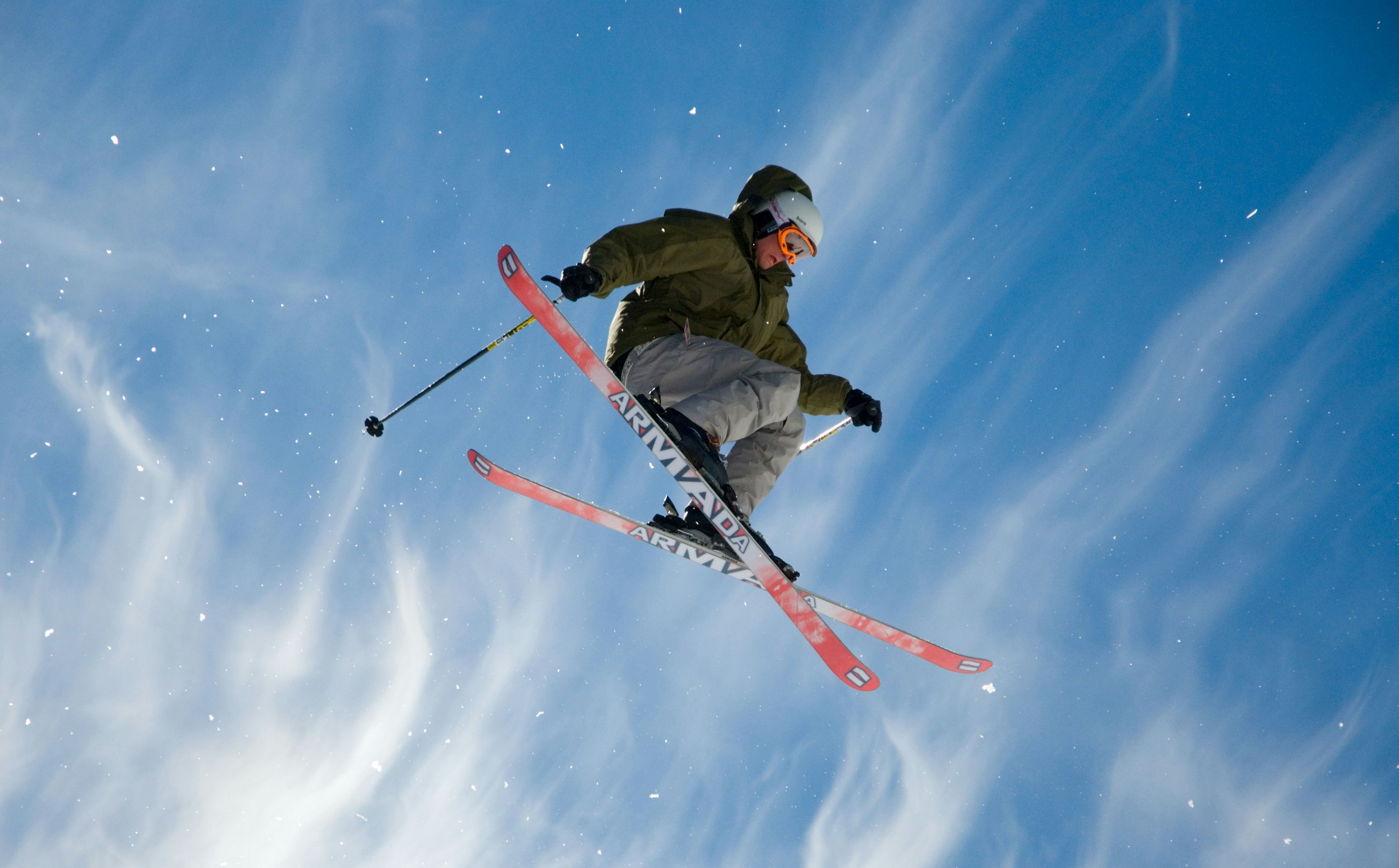 Idaho A skier flies high on a beautiful blue sky day with dramatic clouds