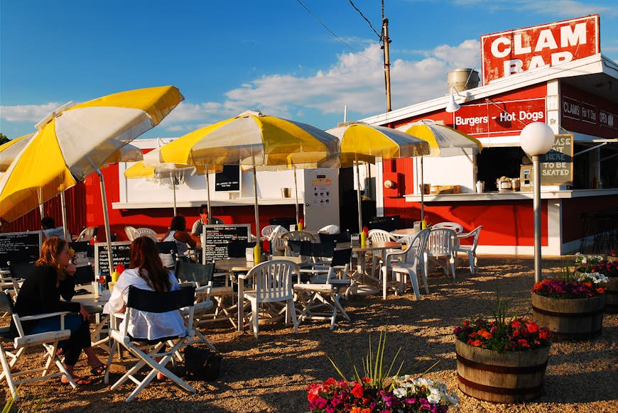 Folks enjoy a casual meal at a clam shack in East Hampton, New York.  The diner, located on the road to Montauk, is a popular lunch spot in the Hamptons. 