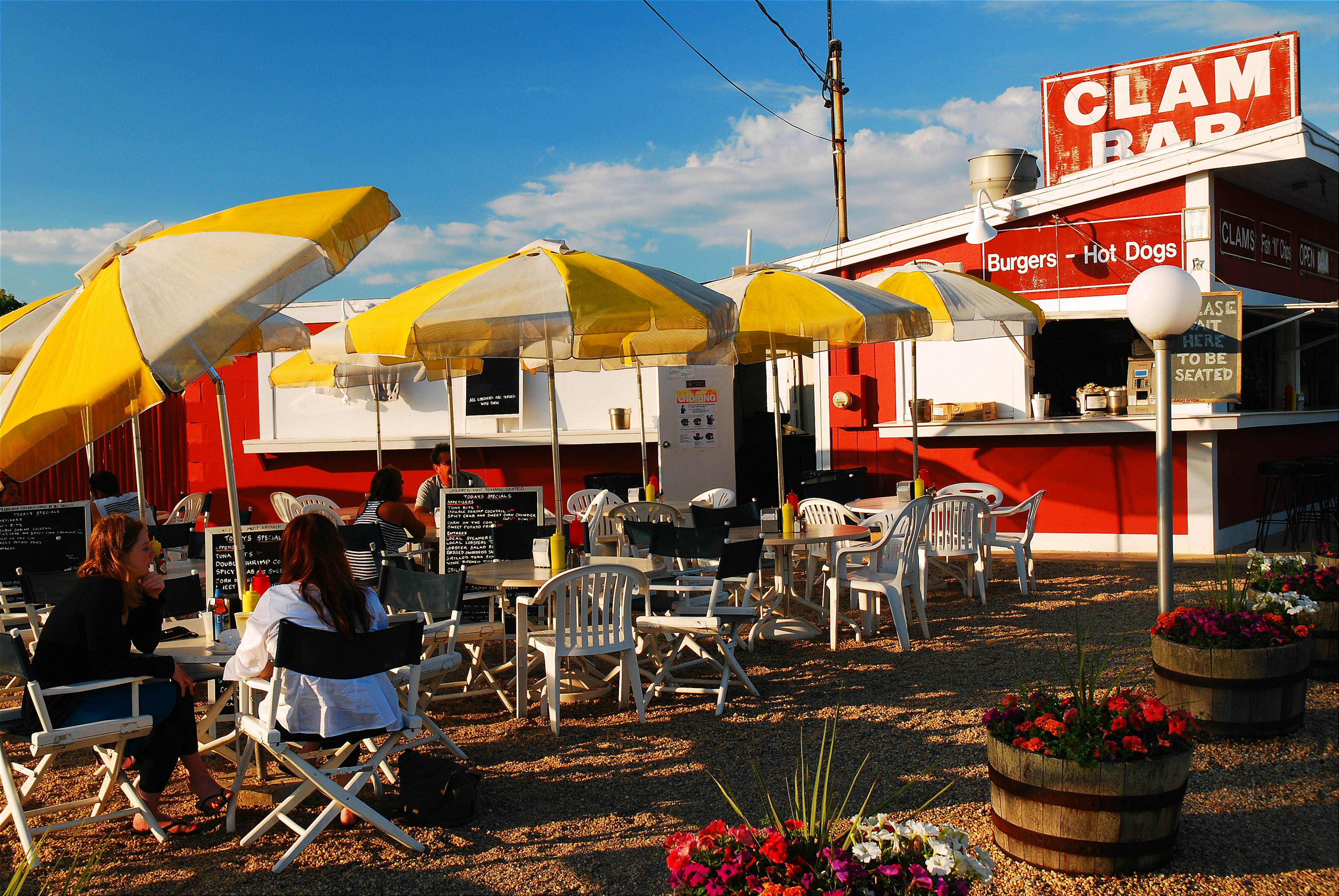 Folks enjoy a casual meal at a clam shack in East Hampton, New York.  The diner, located on the road to Montauk, is a popular lunch spot in the Hamptons.