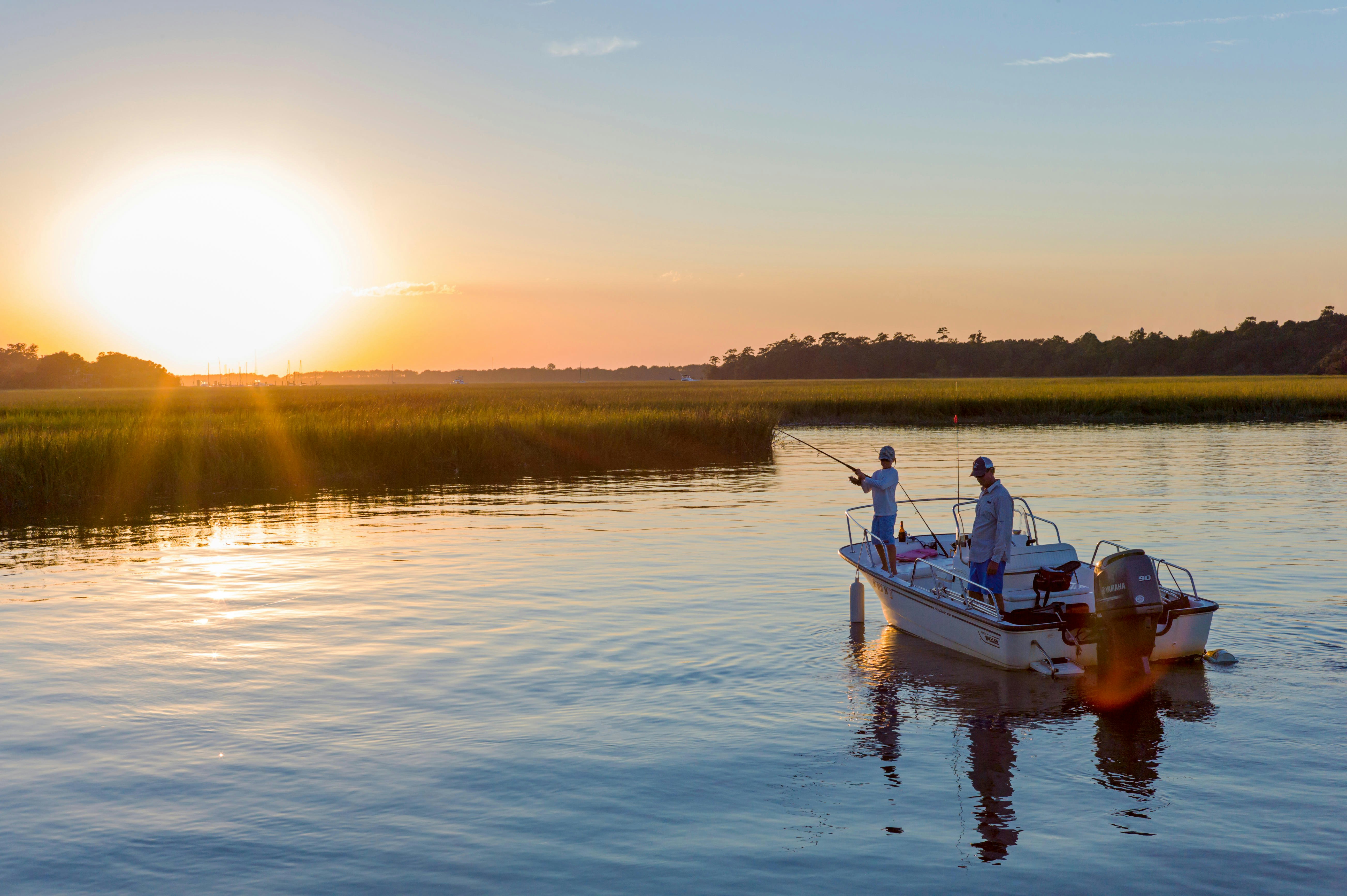 Father and son fishing at sunset; inland bay near Charleston; South Carolina; USA