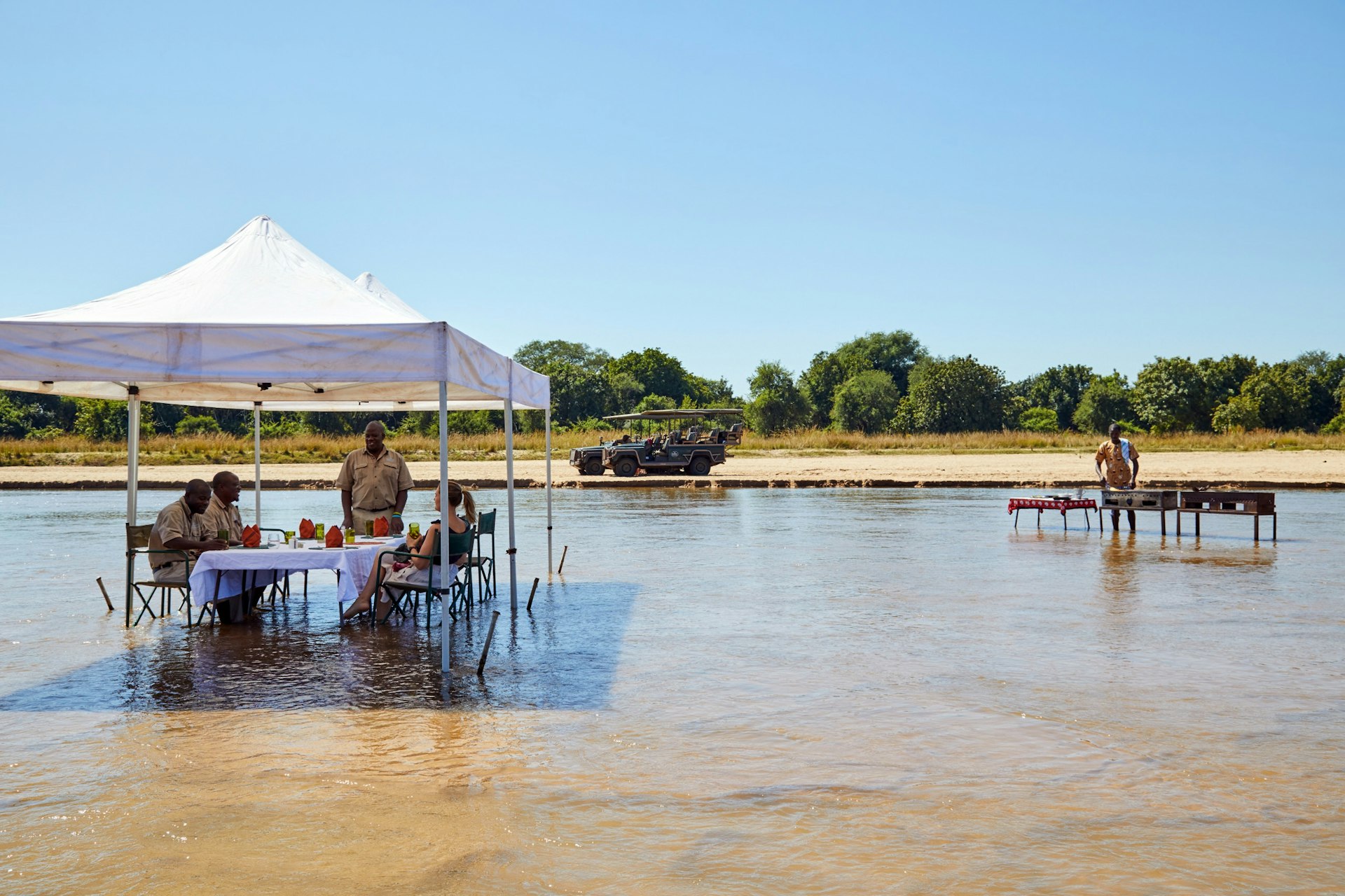 Al fresco dining on Kapamba River at the Kapamba Bushcamp, part of The Bushcamp Company in South Luangwa National Park