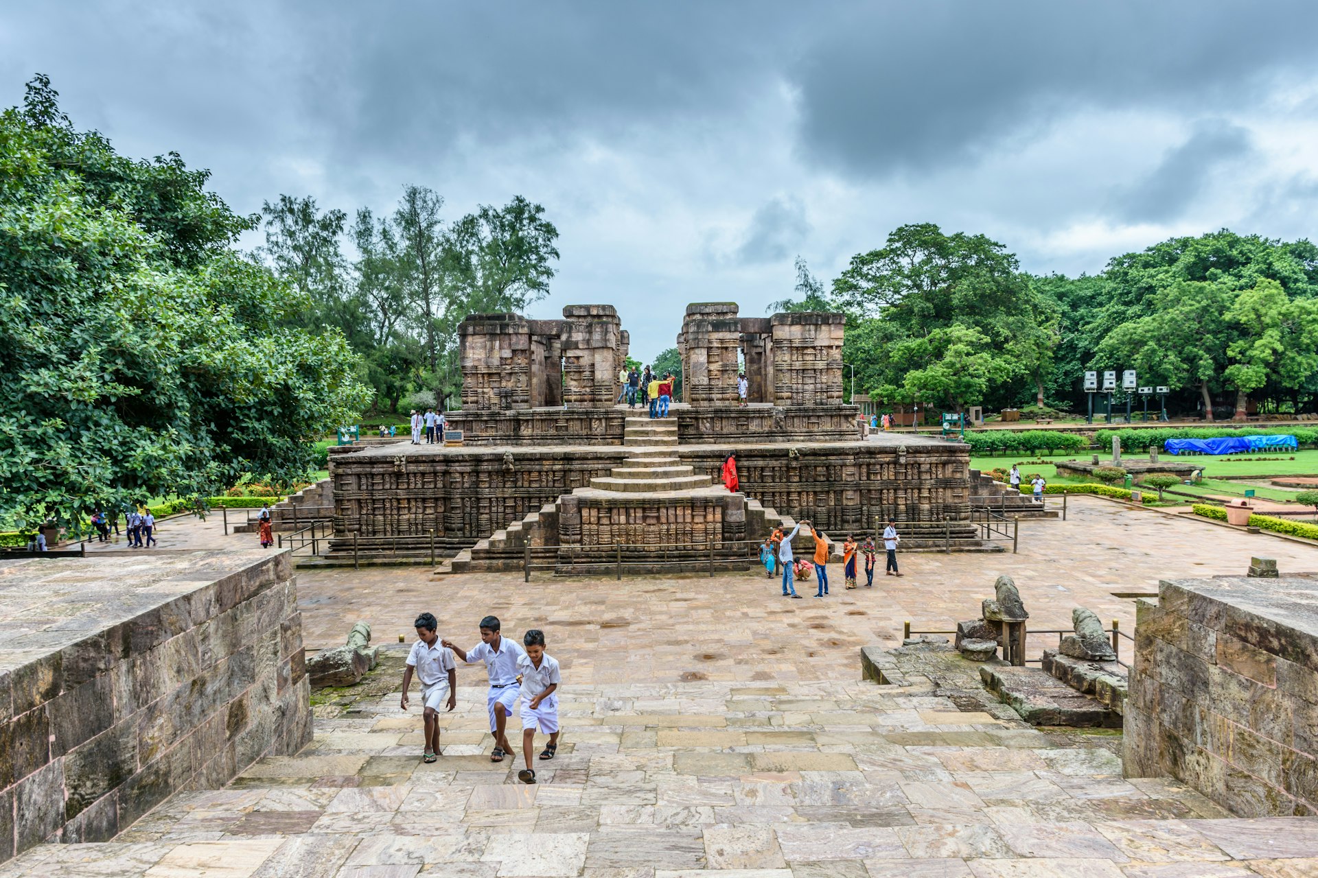 Kids run up the paths near an ancient temple in India. 