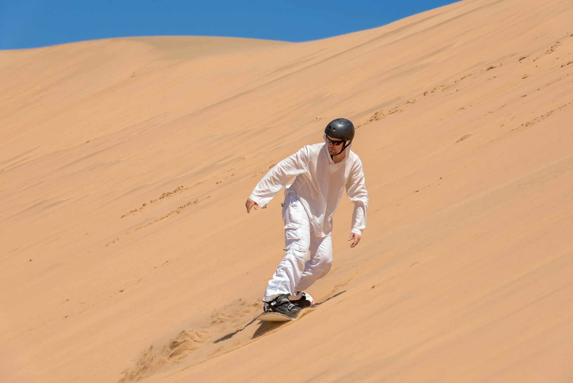 Sandboarder in action near Swakopmund, Namibia