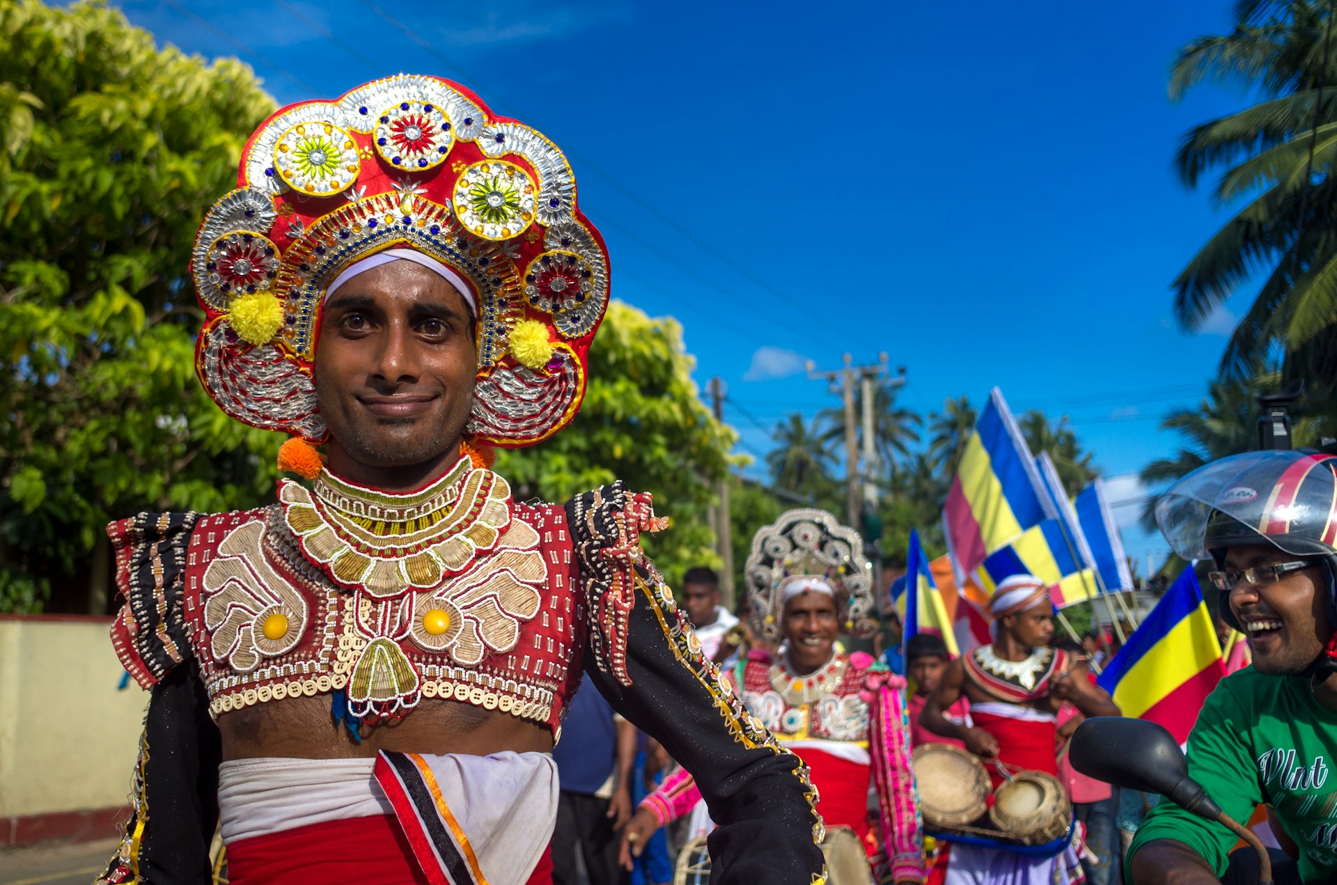 Dressed dancers on the street celebrating Poya Day near Unawatuna