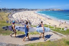 Sydney, Australia - November 19, 2015: Three surfers heading to the Bondi Beach Bondi beach with their surf boards on a sunny day.
