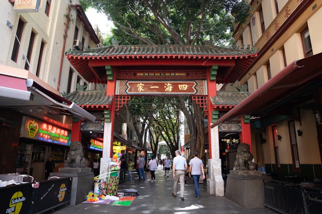 People walking through The arch gate of china town (Paifang) on Dixon in Sydney,