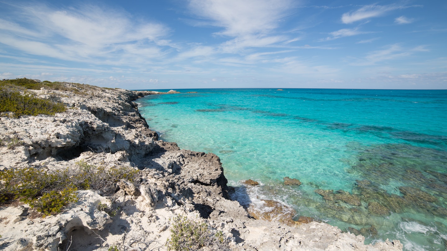 Warderick Wells, Exuma Cays Land and Sea Park, Bahamas - sparkling clear waters from a cliffside hiking trail in the Bahamas National Trust Park; Shutterstock ID 705378439; your: Sloane Tucker; gl: 65050; netsuite: Online Editorial; full: Bahamas Hikes Article