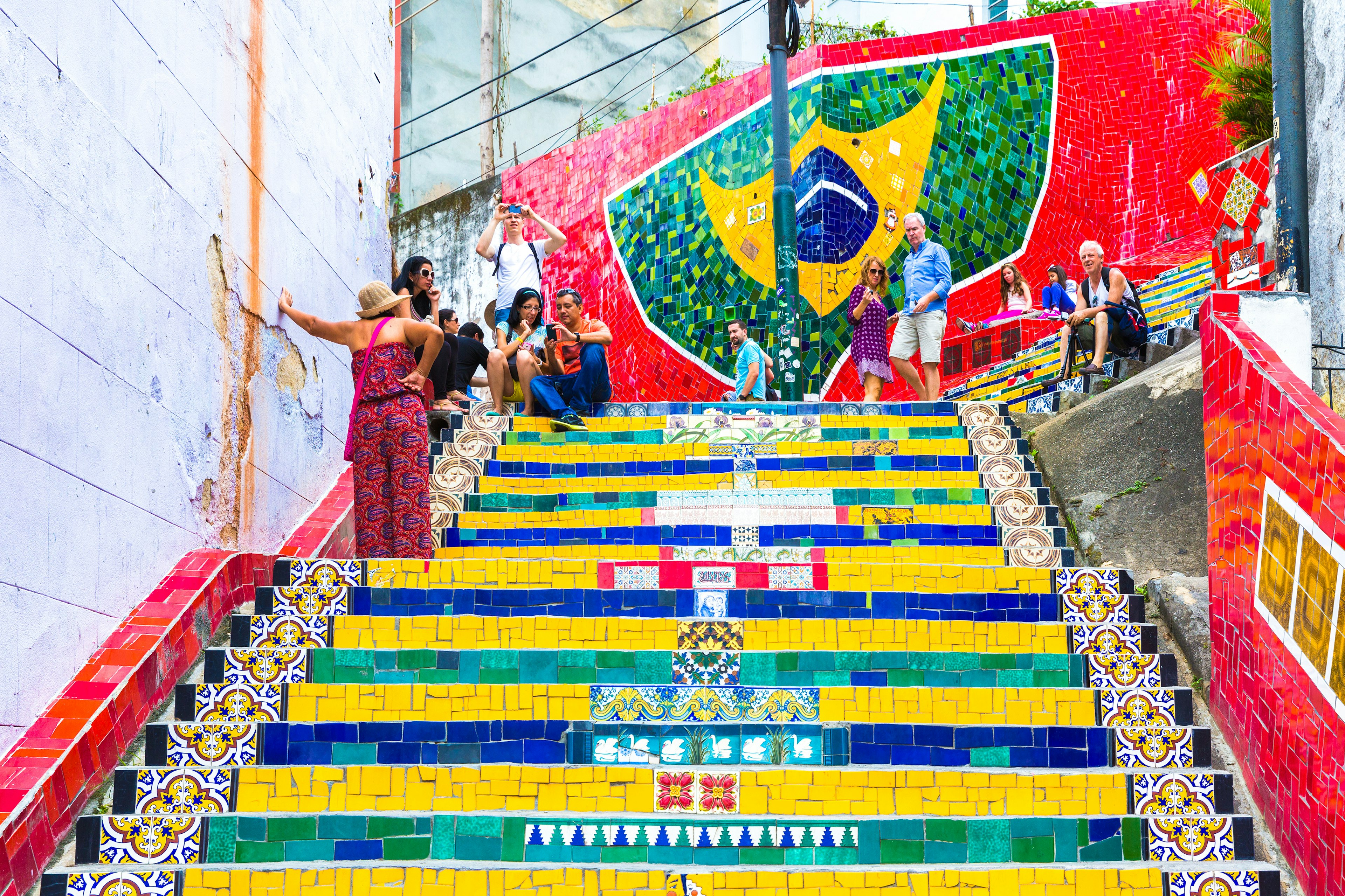 Tourists visiting the brightly painted Selaron stairway in Rio de Janeiro, Brazil. The stairway is the work of Chilean artist Jorge Selaron.