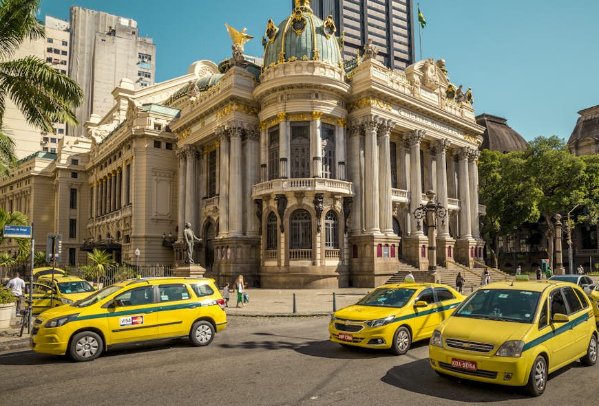 Street full of taxi cars with Theatro Municipal in the background in Rio de Janeiro, Brazil