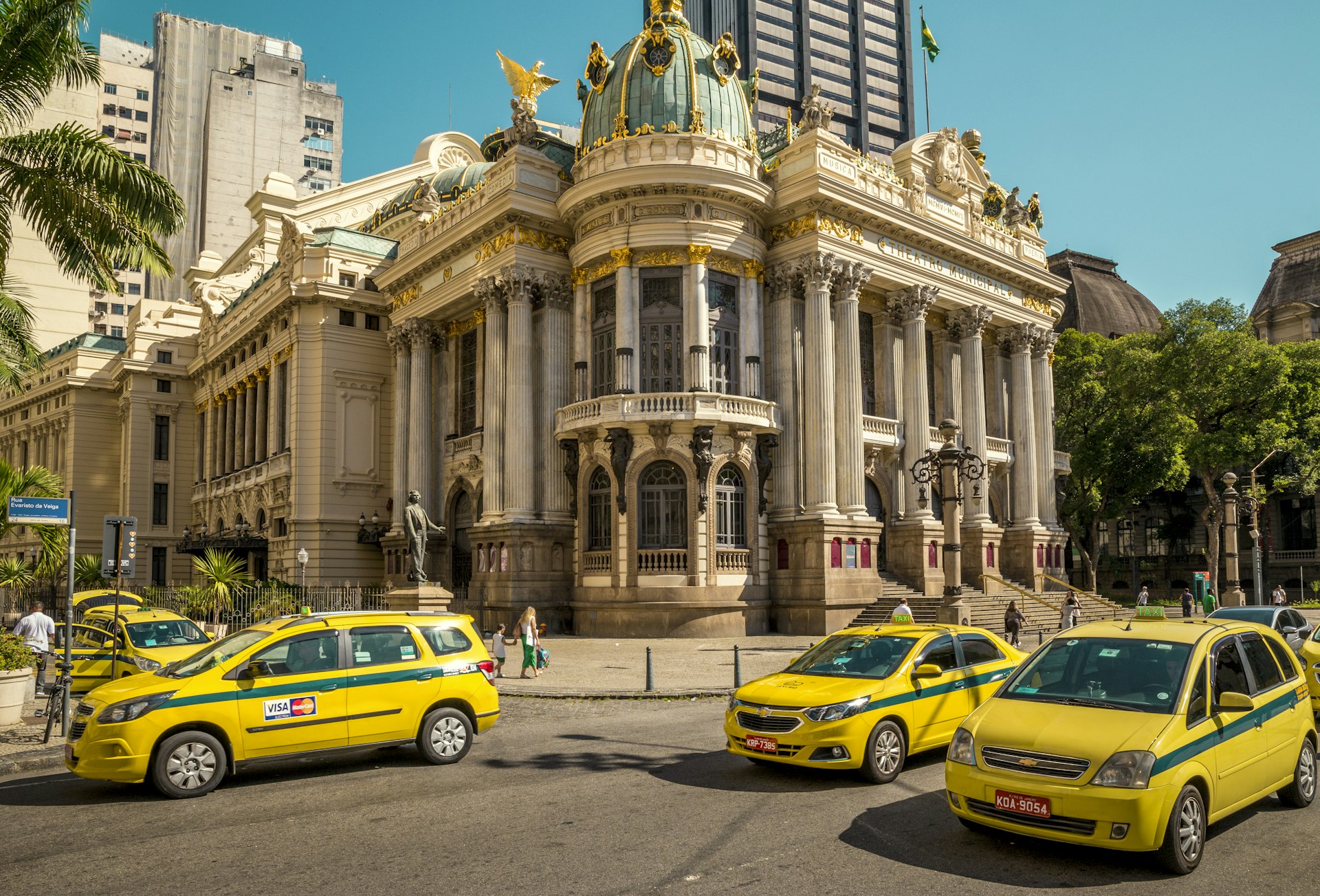 Street full of taxi cars with Theatro Municipal in the background in Rio de Janeiro, Brazil