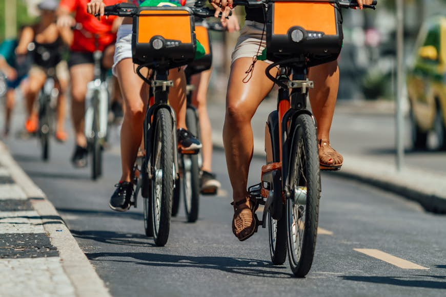 Several cyclists pass through a bike path in the Copacabana neighborhood (Rio de Janeiro, Brazil)