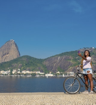 Black beautiful brazilian woman stops her bike ride in Rio de Janeiro to make a selfie