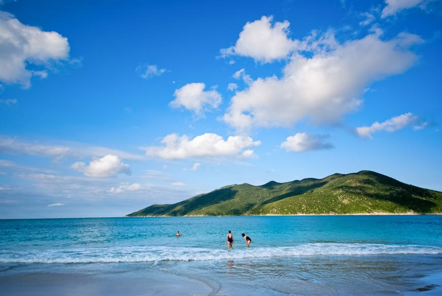 American tourists take a dip in the pristine Atlantic Ocean at Prainha Beach, near Rio de Janeiro