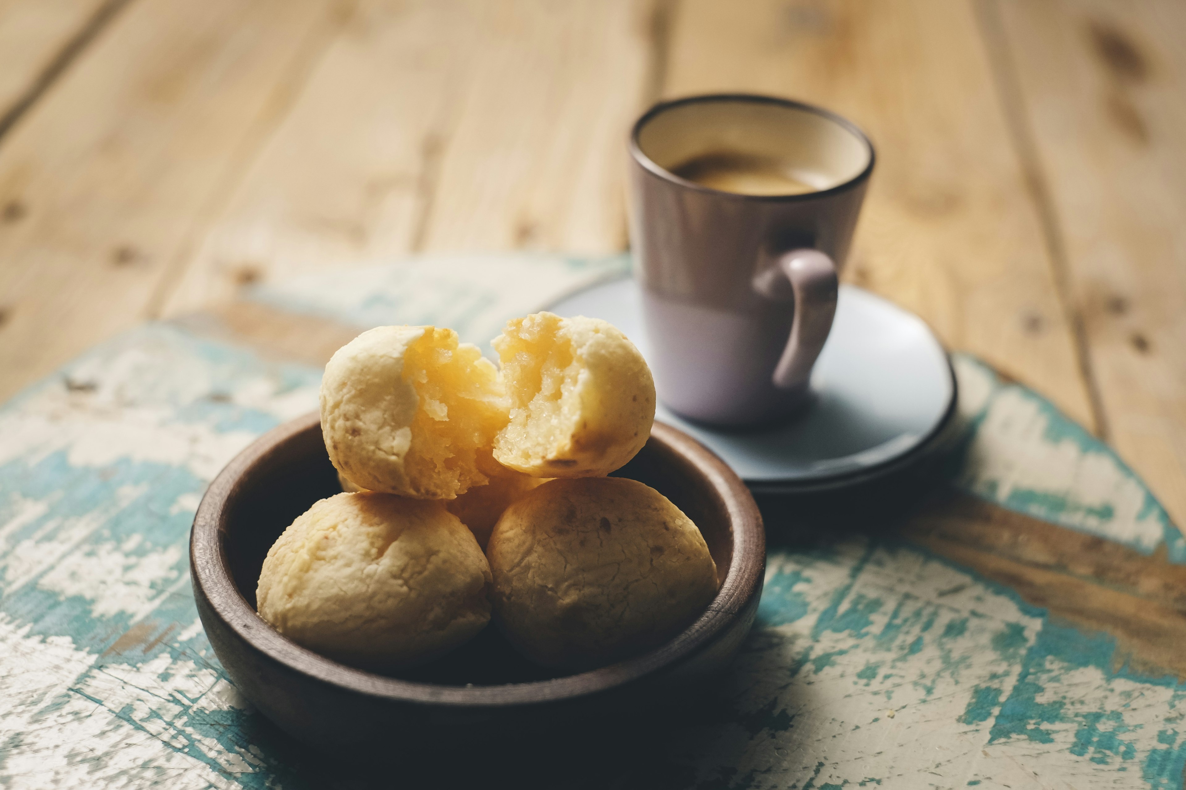 Bowl of pão de queijo (cheese bread) and a cup of coffee in Brazil