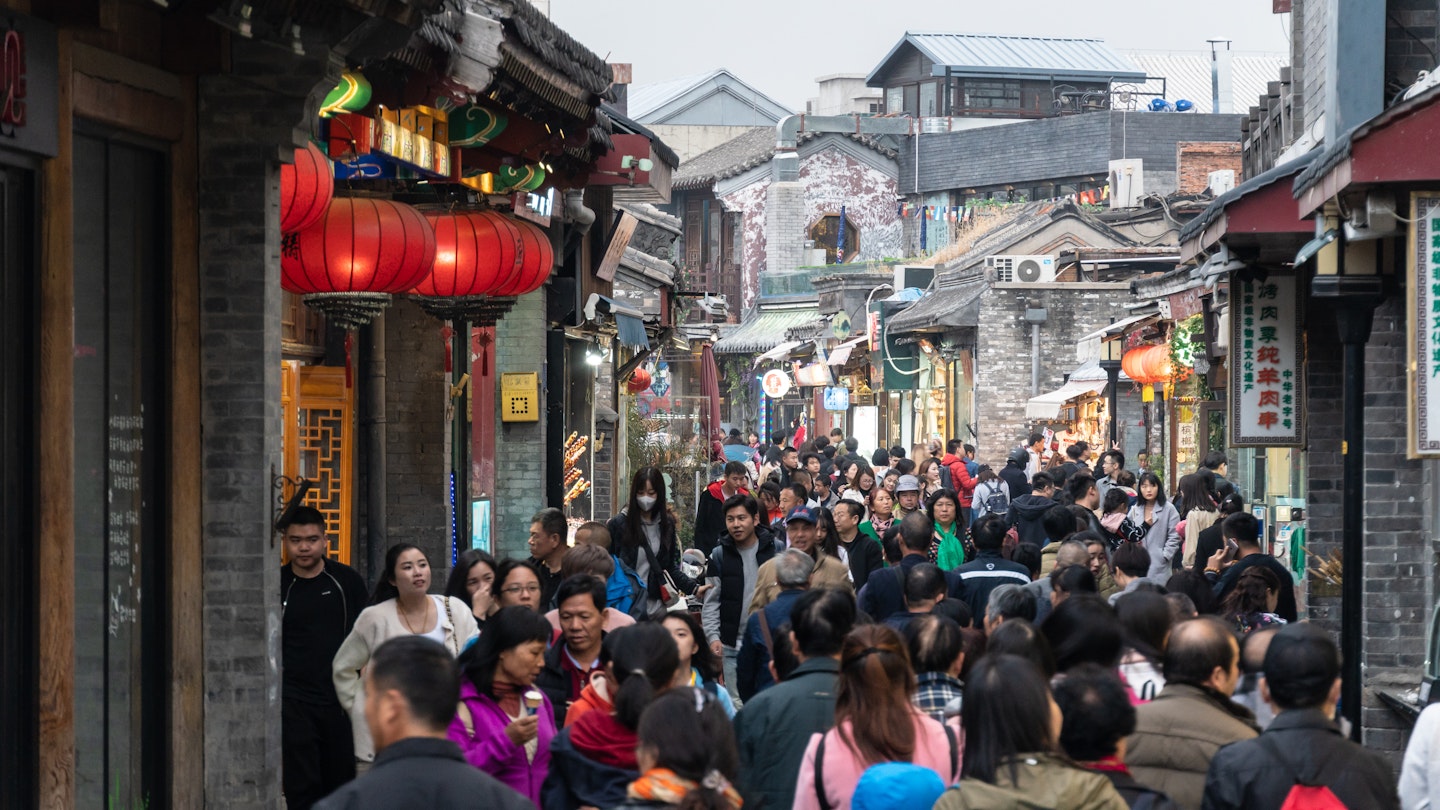 large group of Chinese tourist in the Shichahai hutong old town area in Beijing, China capital city