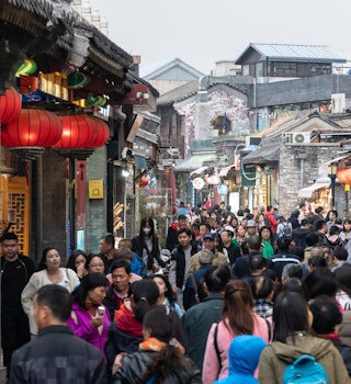 large group of Chinese tourist in the Shichahai hutong old town area in Beijing, China capital city