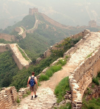 A young man hikes alone along the Great Wall of China. This section is between Jinshanling and Simatai.Please see some similar pictures from my portfolio: