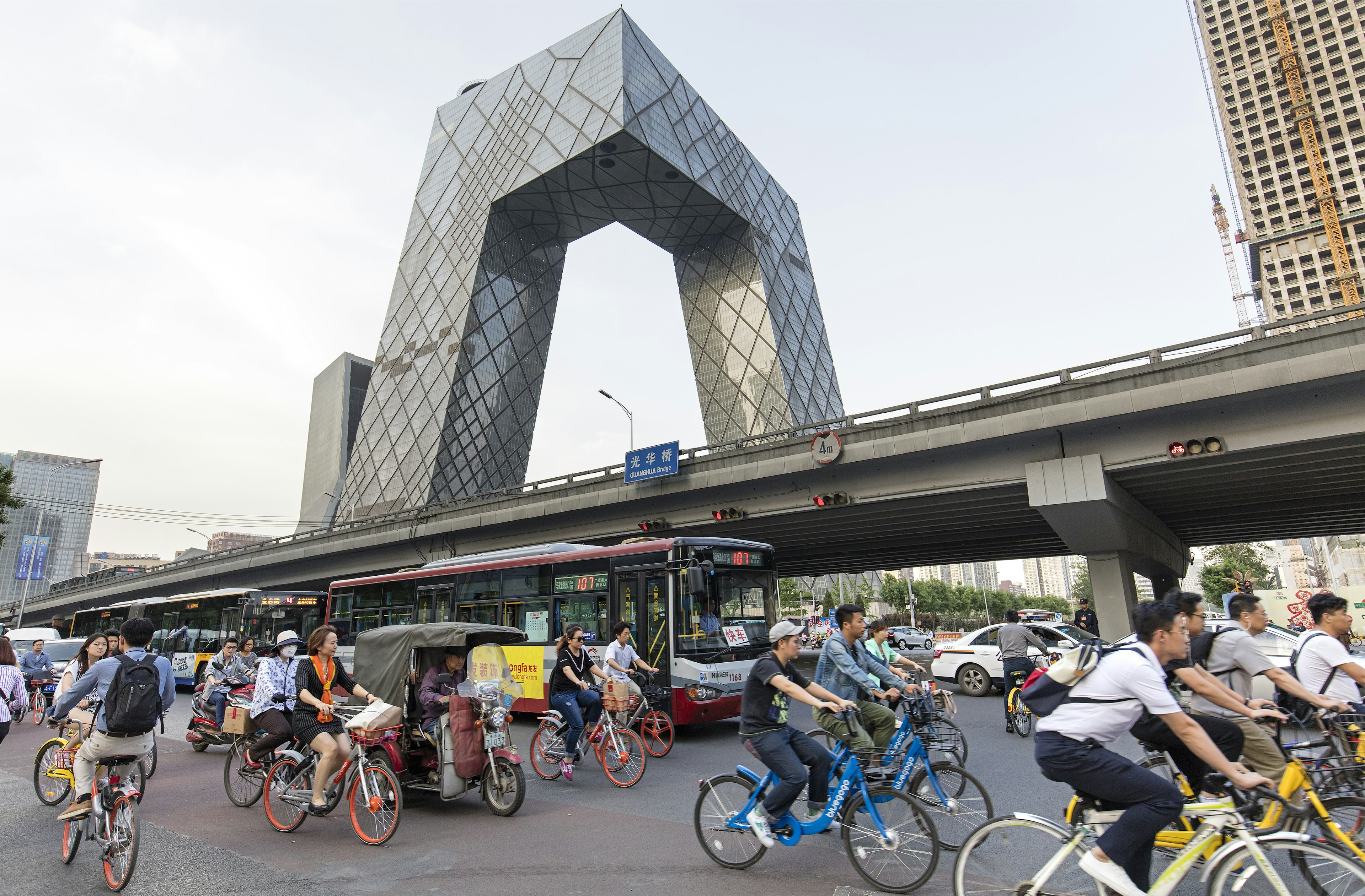 Commuters and heavy traffic around Beijing's Guomao area during rush hour