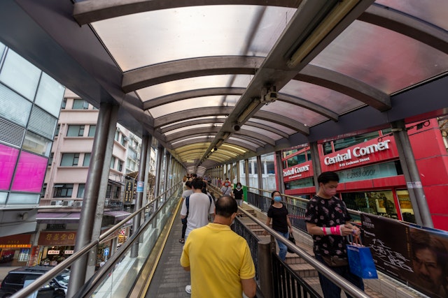 People at the Central - Mid-Levels escalator and walkway system in Hong Kong, the longest outdoor covered escalator system in the world