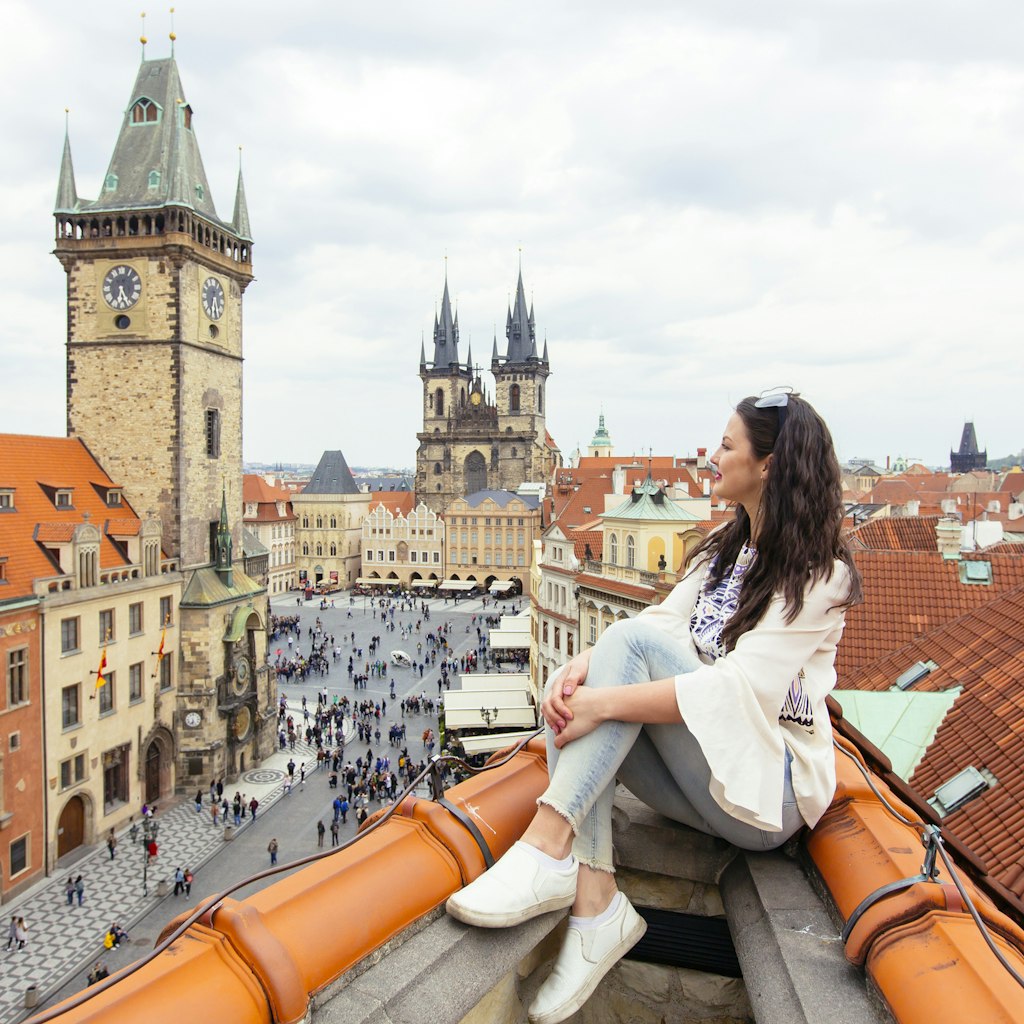 Happy tourist looking at the Old Town Square from above, Prague, Czech Republic 