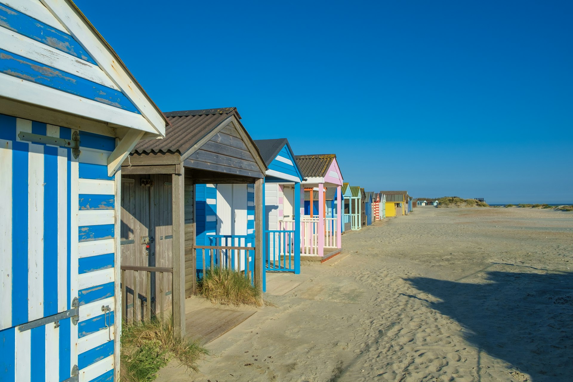 A row of colorful beach huts, West Wittering, UK