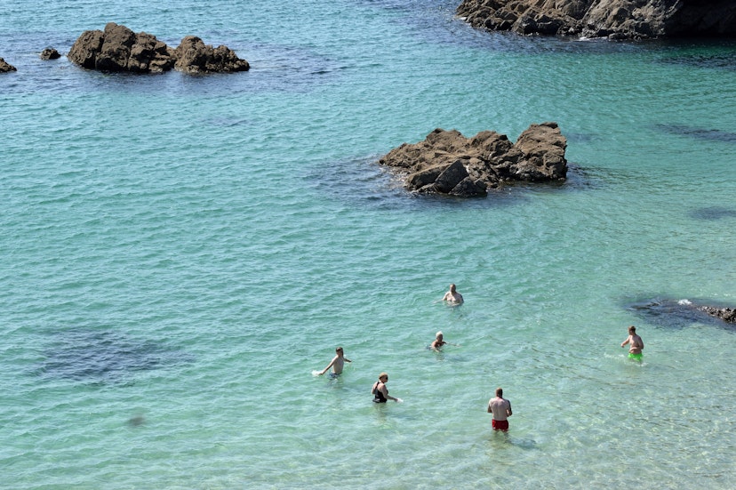 Kynance Cove, Cornwall - 20 July 2021: swiming in Kynance Cove; Shutterstock ID 2153041741; your: Sloane Tucker; gl: 65050; netsuite: Online Editorial; full: England Beaches Article