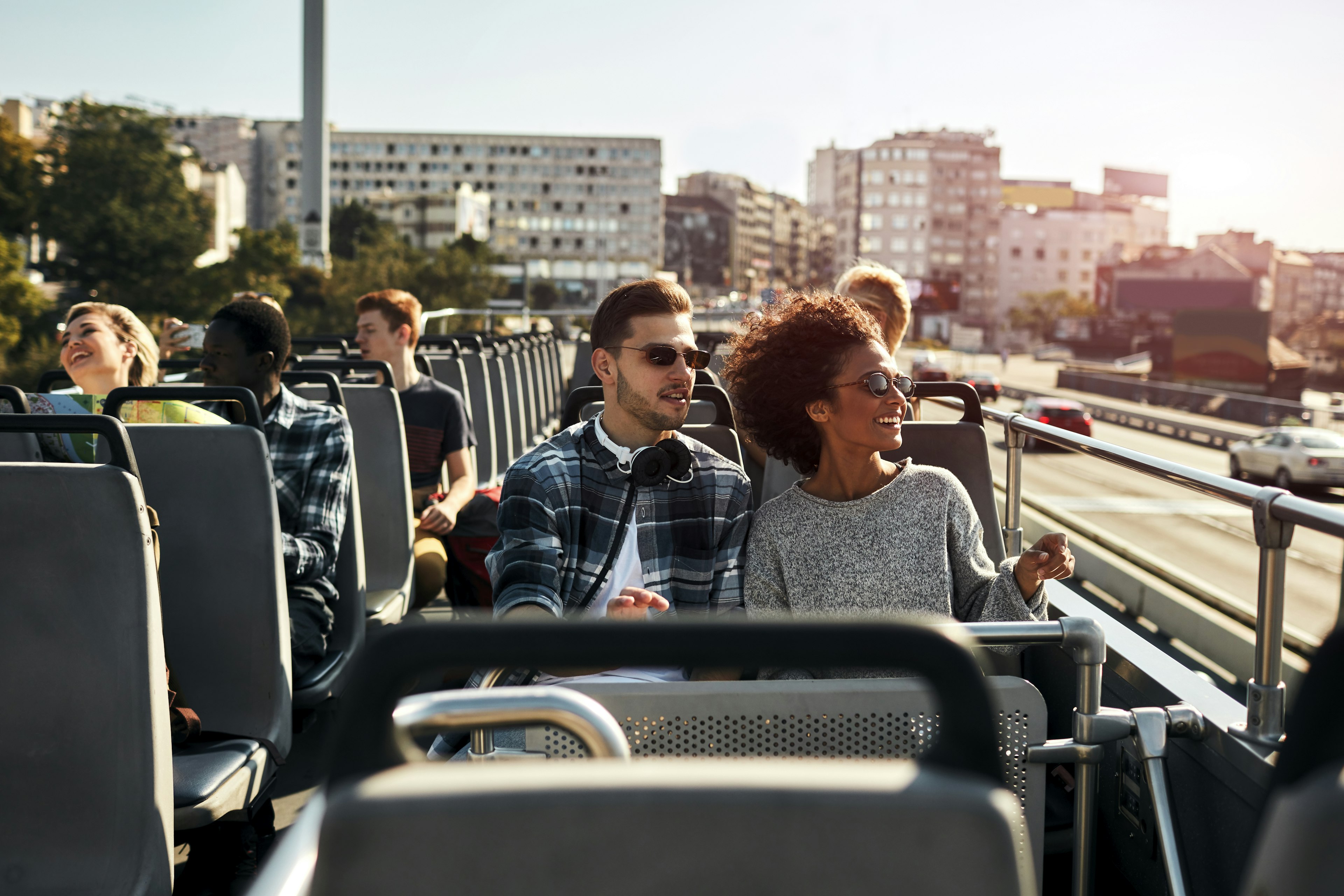 Enjoying the fresh air of a double-decker bus as you get the lay of the land in your new destination