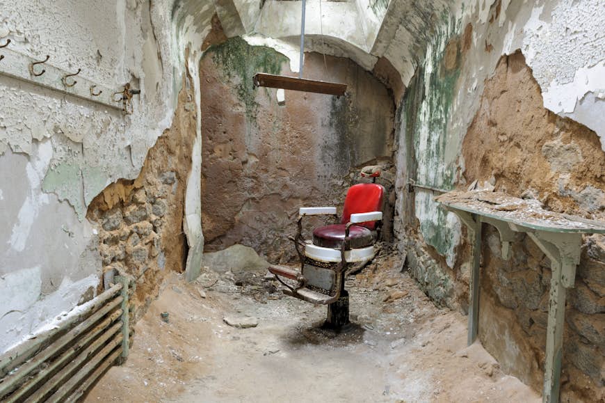 Barber chair in a decaying and empty prison cell in Eastern State Penitentiary, Philadelphia
