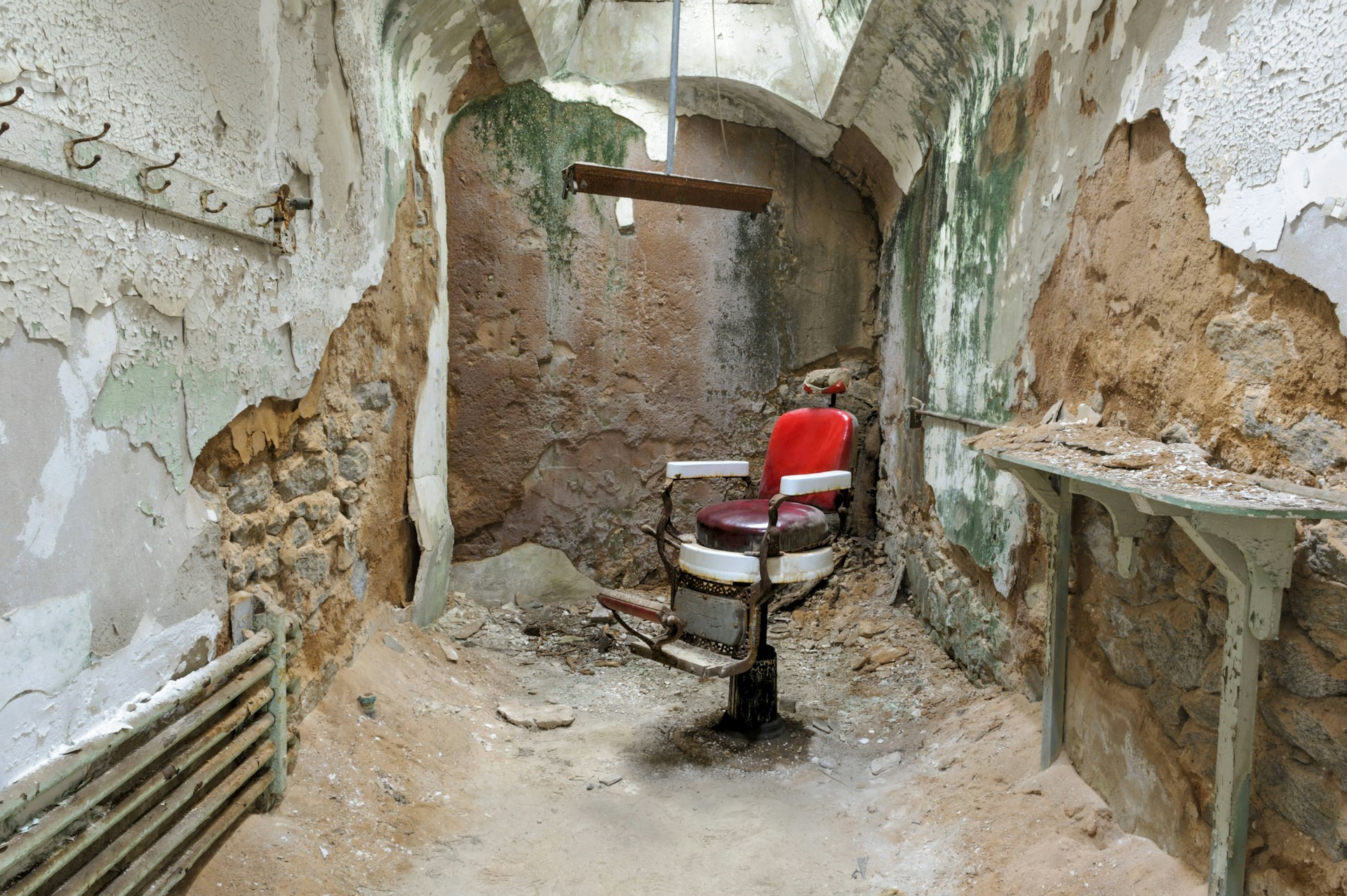 A barber chair sits in a decaying prison cell at Eastern State Penitentiary in Philadelphia