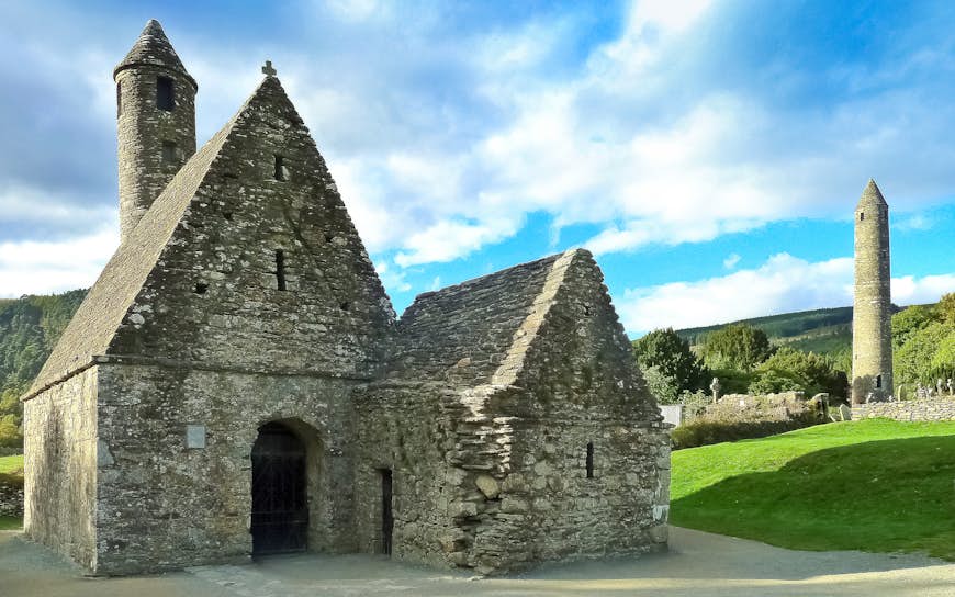 Image of 'St. Kevin's Kitchen' (also known as 'St. Kevin's church'), the Celtic Round Tower and the medieval cemetery in Glendalough, County Wicklow, Ireland