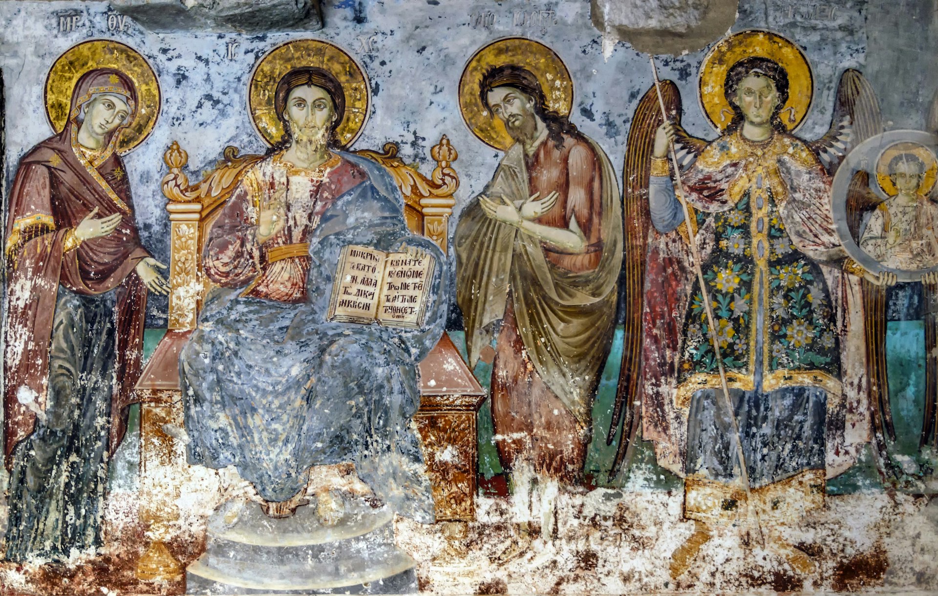 Timeworn frescoes of saints on the outer side of the Church of Protaton in Karyes, Mount Athos