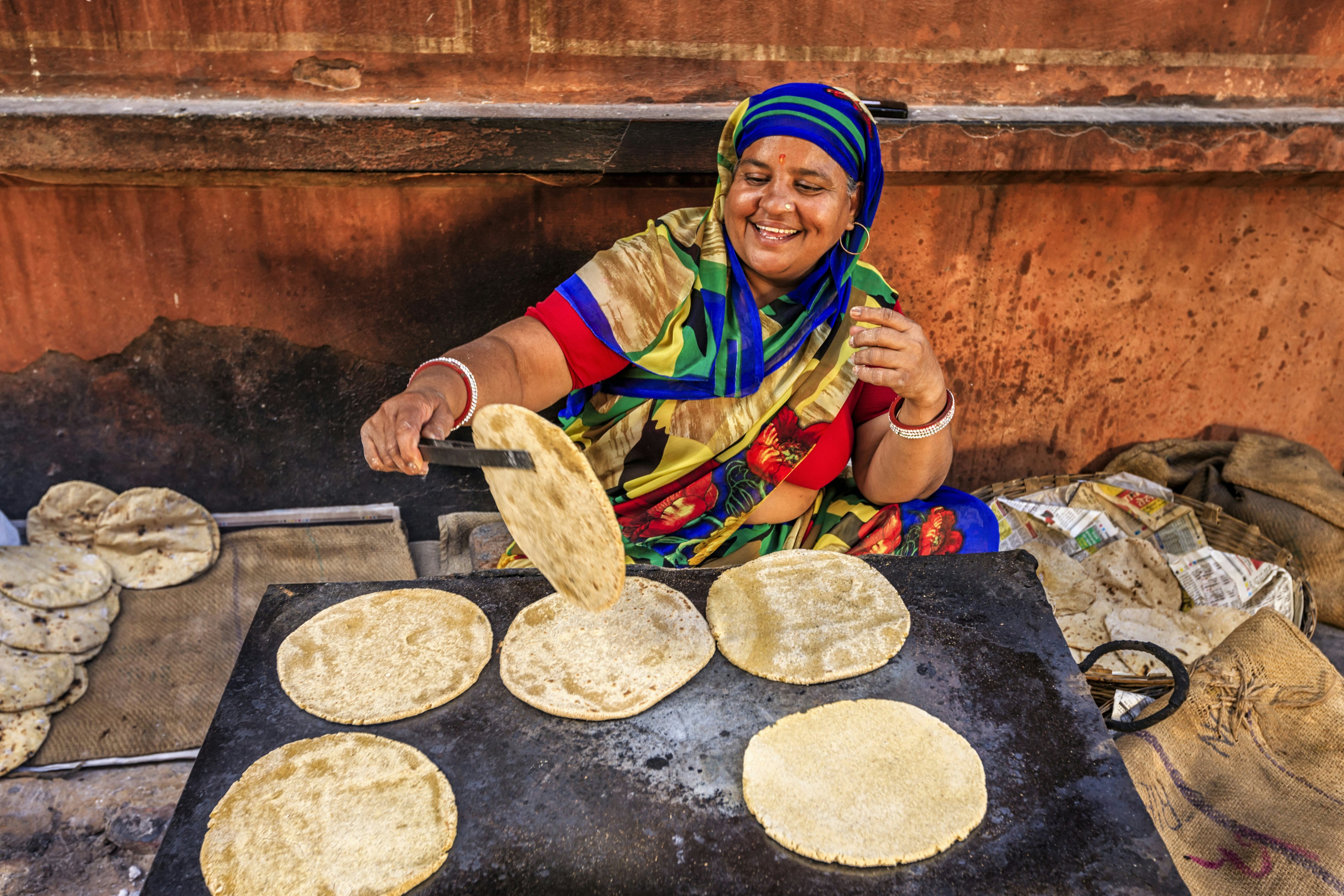 Indian street vendor preparing a chapatti flat bread in Jaipur, Rajasthan, India.